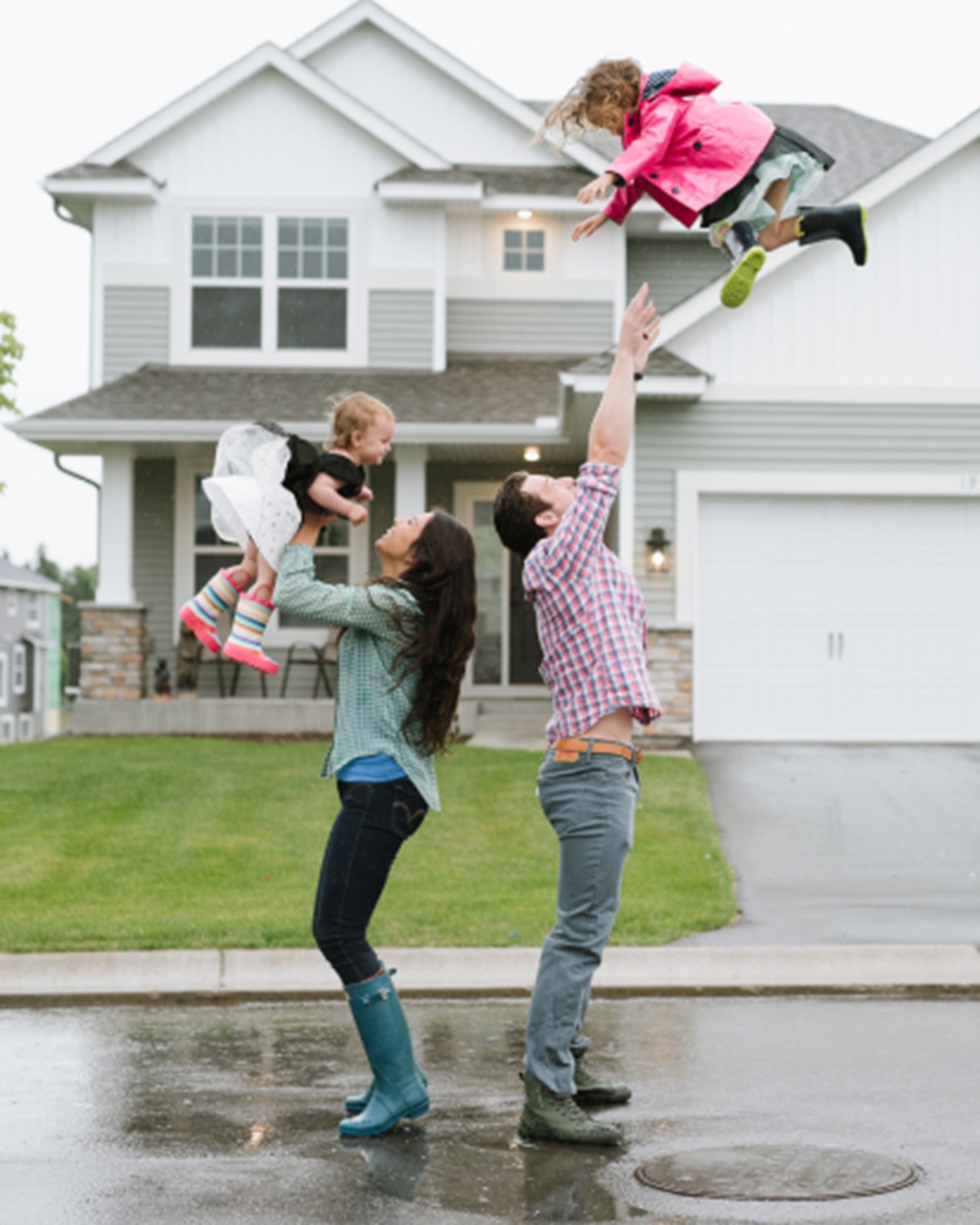 A family playing in the rain