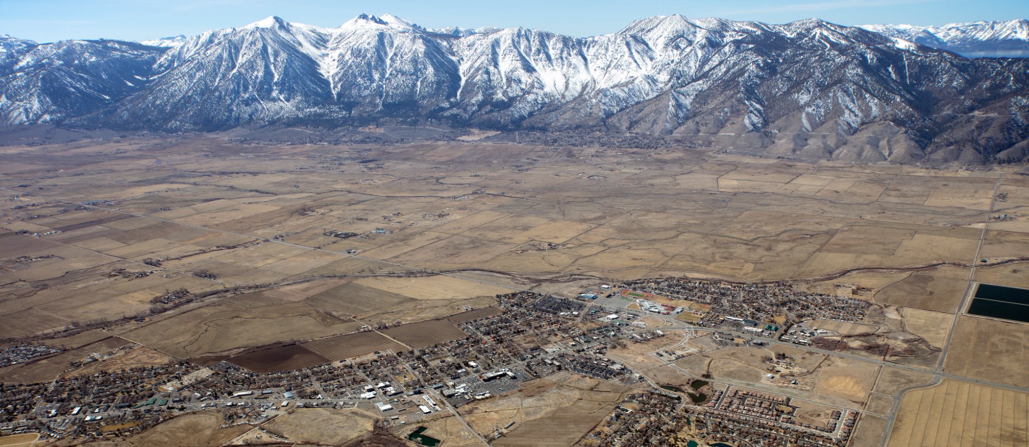 Aerial view of community with mountains in background