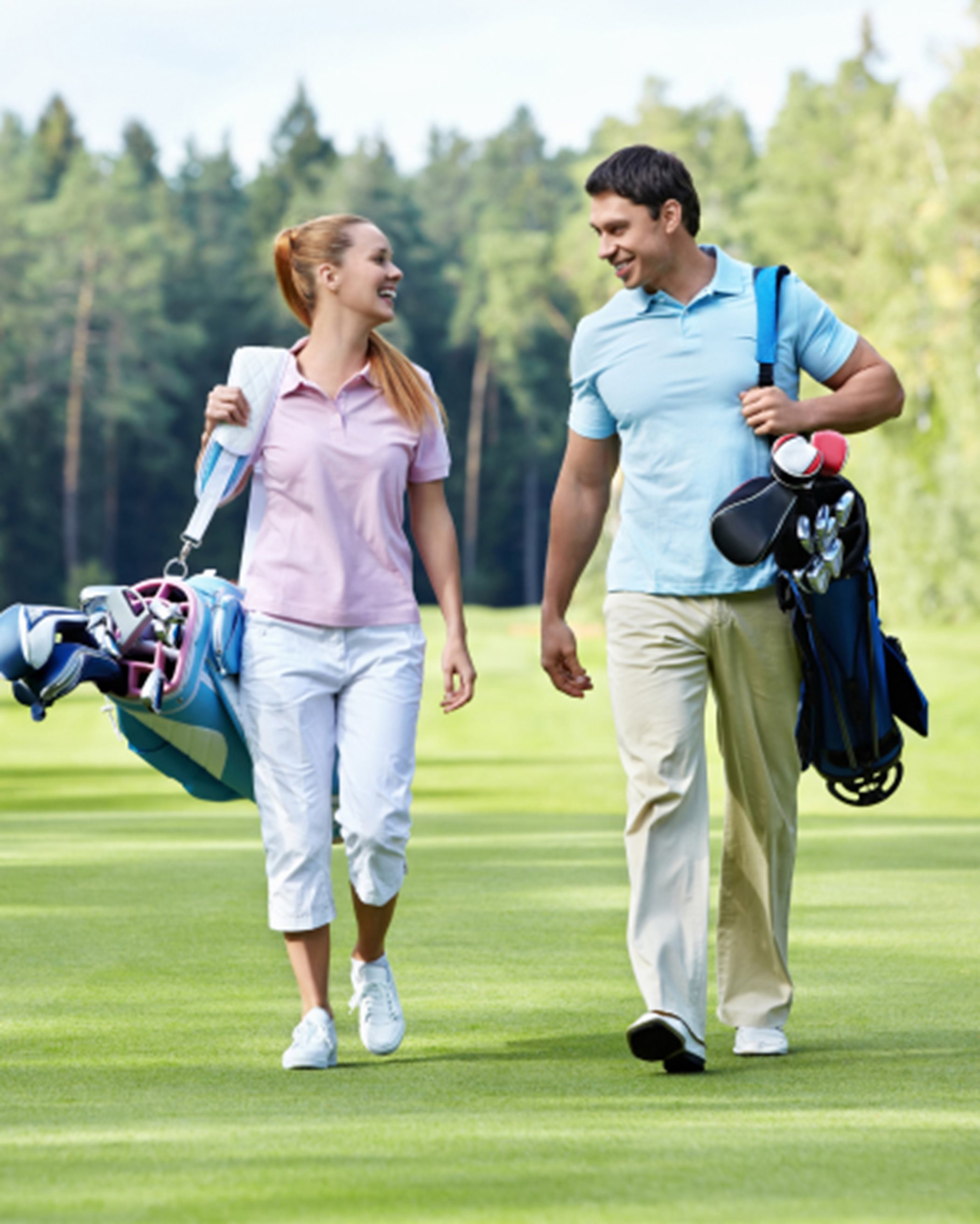 Two people walking on a golf course
