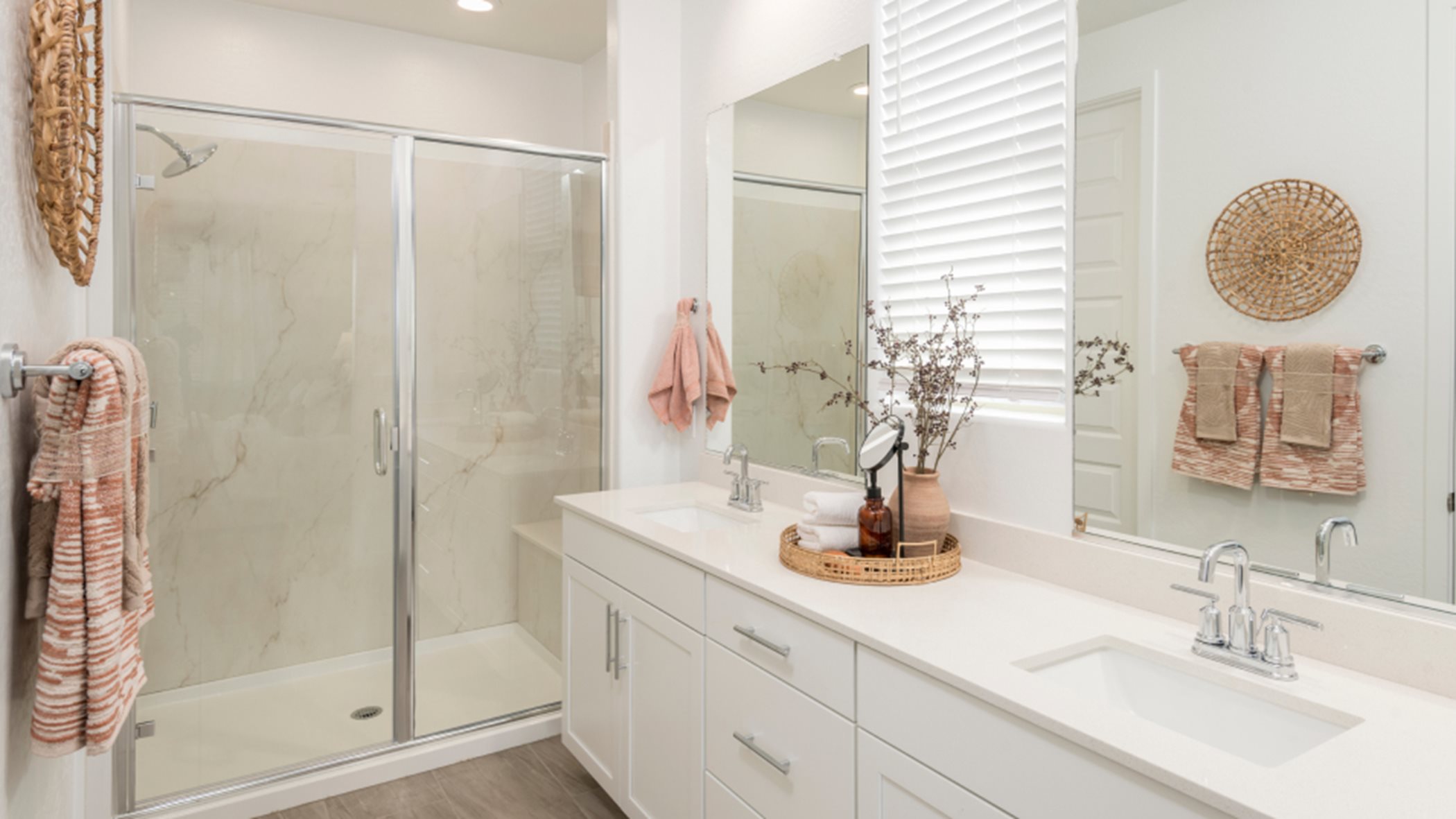 Owner's suite bathroom with dual sinks and glass-enclosed shower