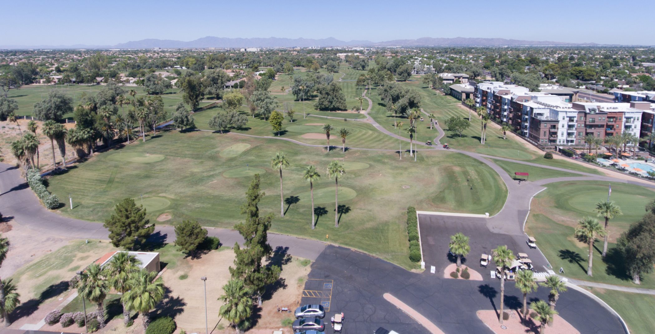 Aerial view of a desert golf course with lots of palm trees