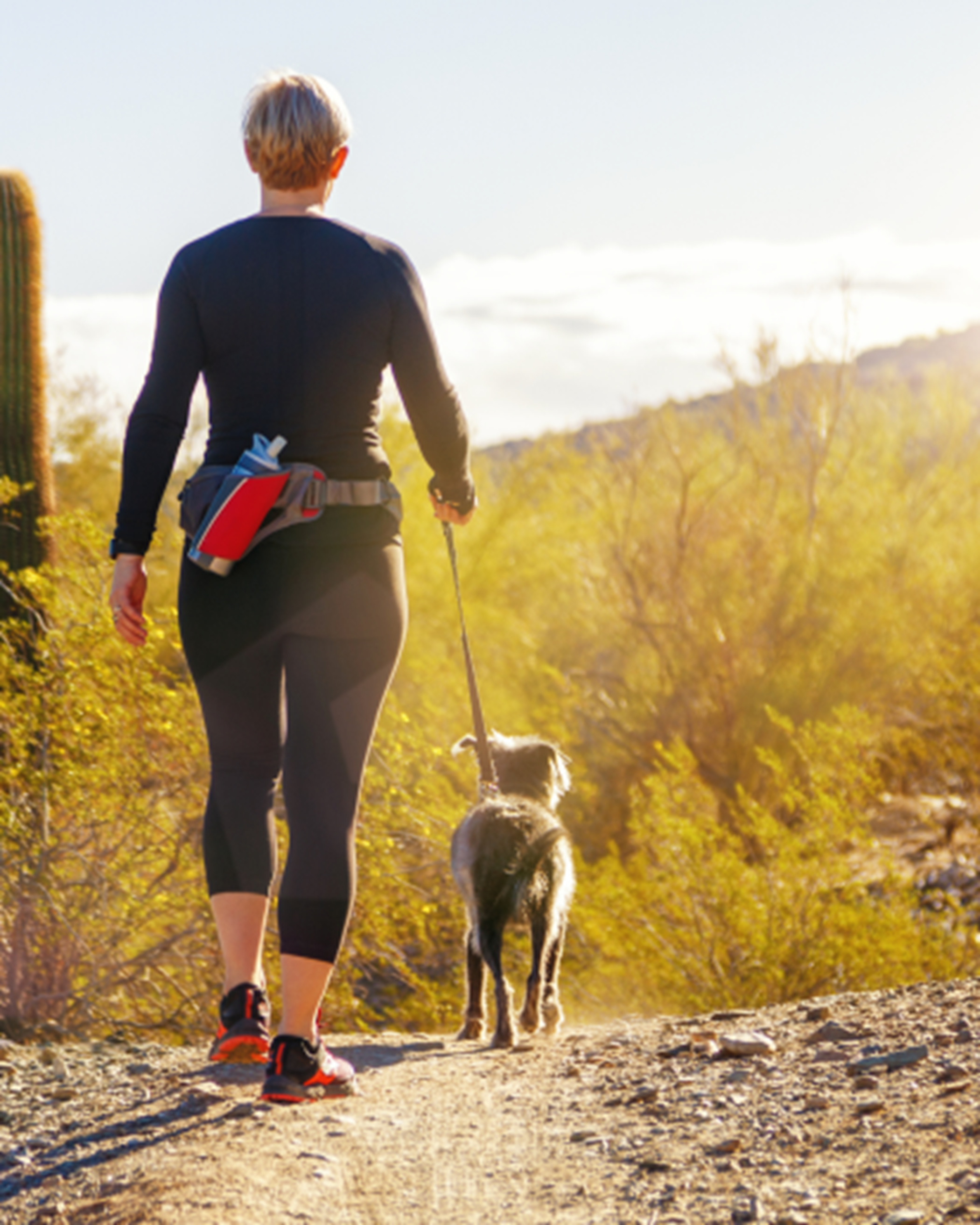 Woman and dog on hiking trail