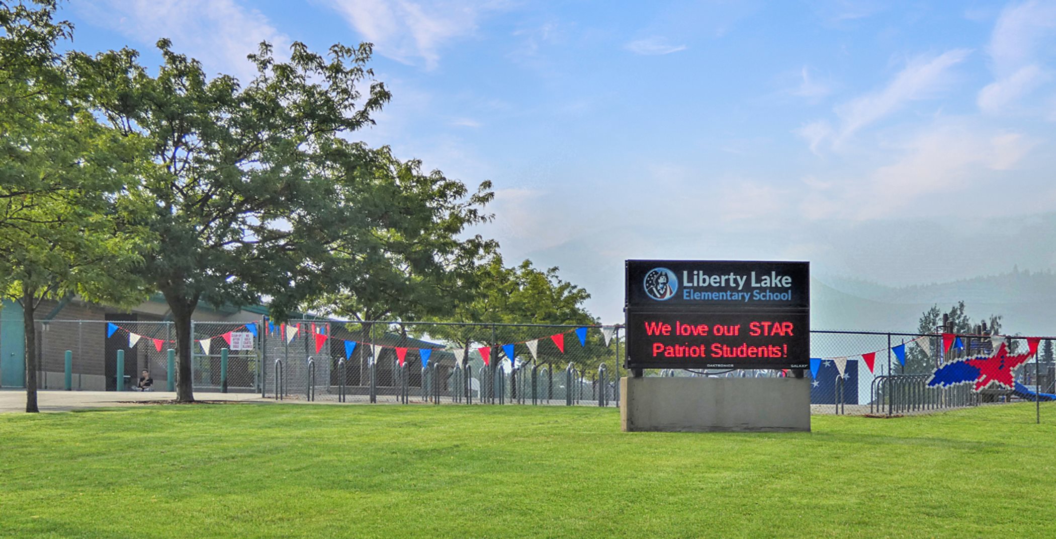 School entrance with automated sign that says, "We love our STAR Patriot Students!"