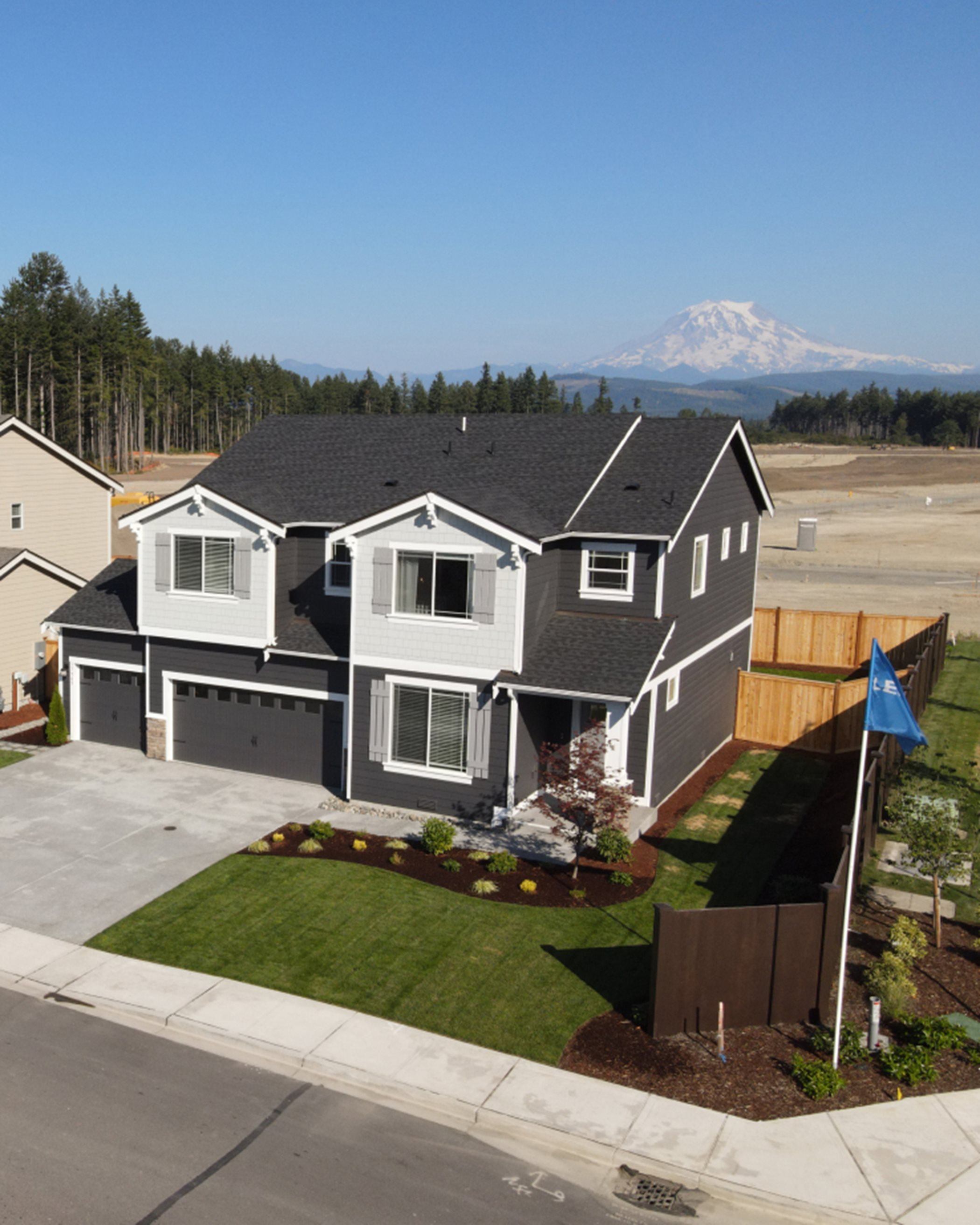 Two-story model homes with horizontal siding and double garages