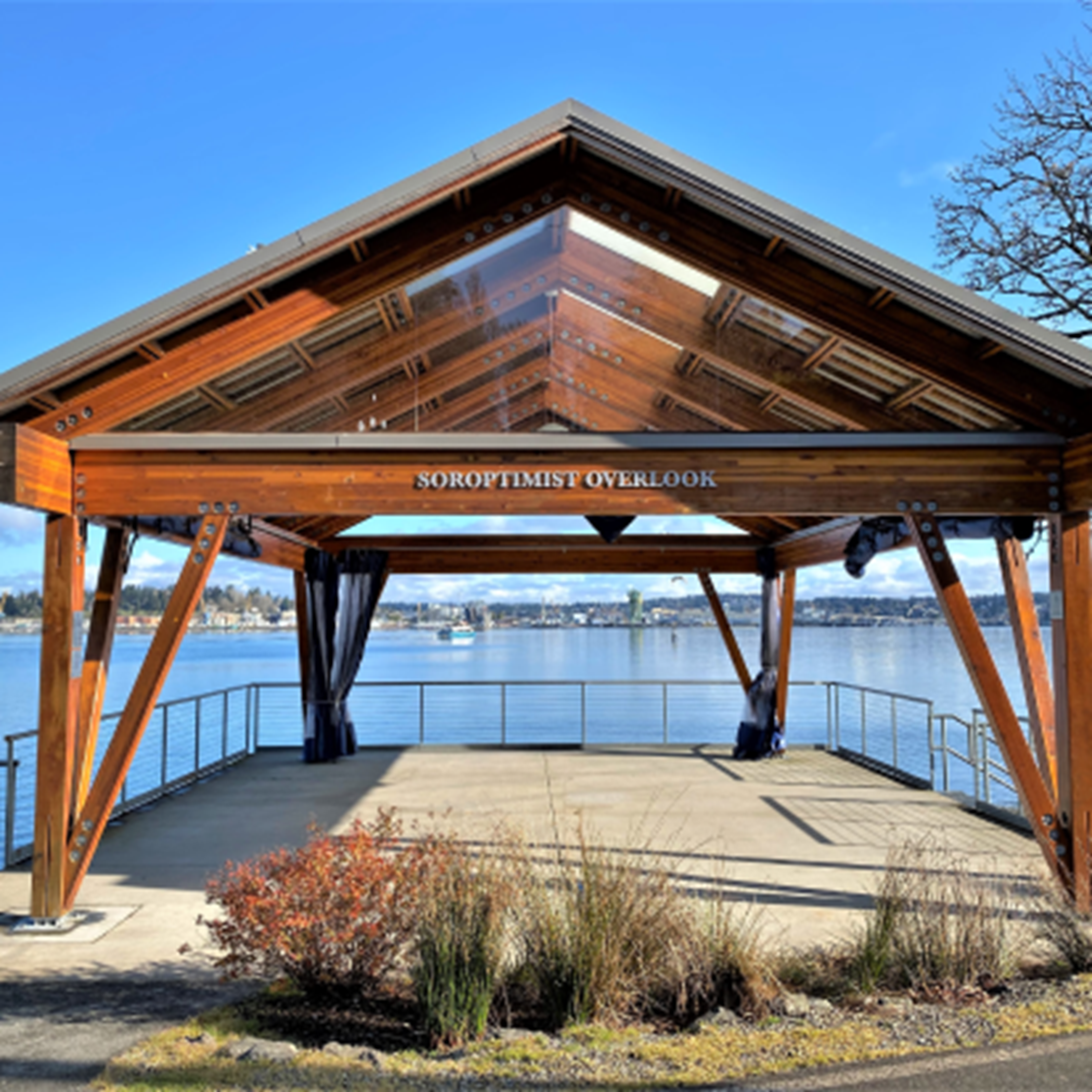 A covered overlook with a gable roof that views the waterfront