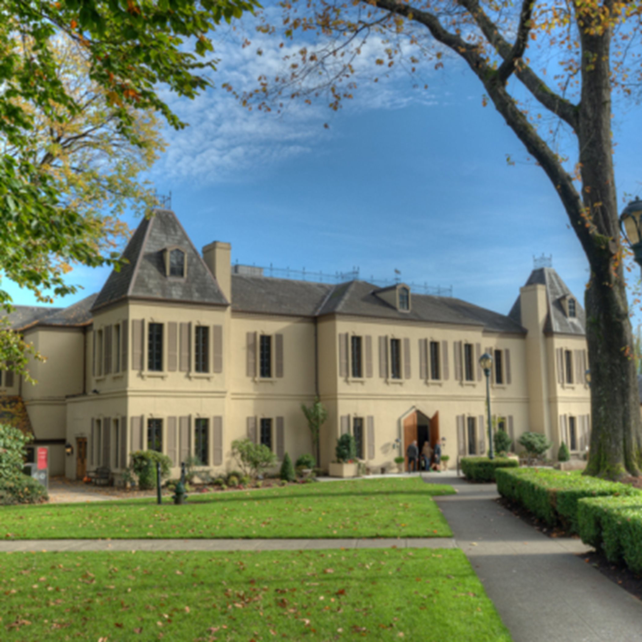 A classic French-style building with hip rooflines, towers and pairs of windows on both floors