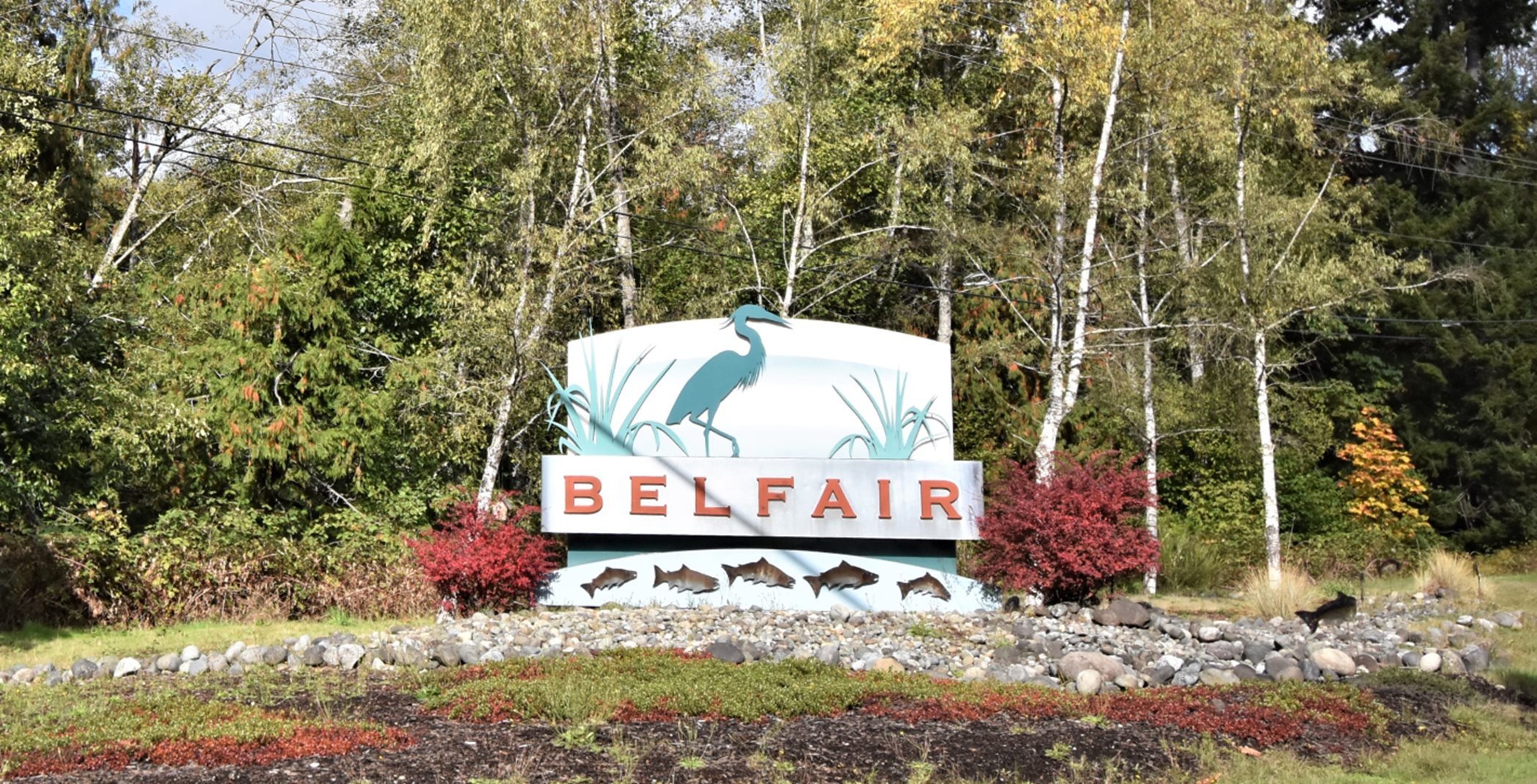 Belfair welcome sign, which features the green silhouette of a crane 