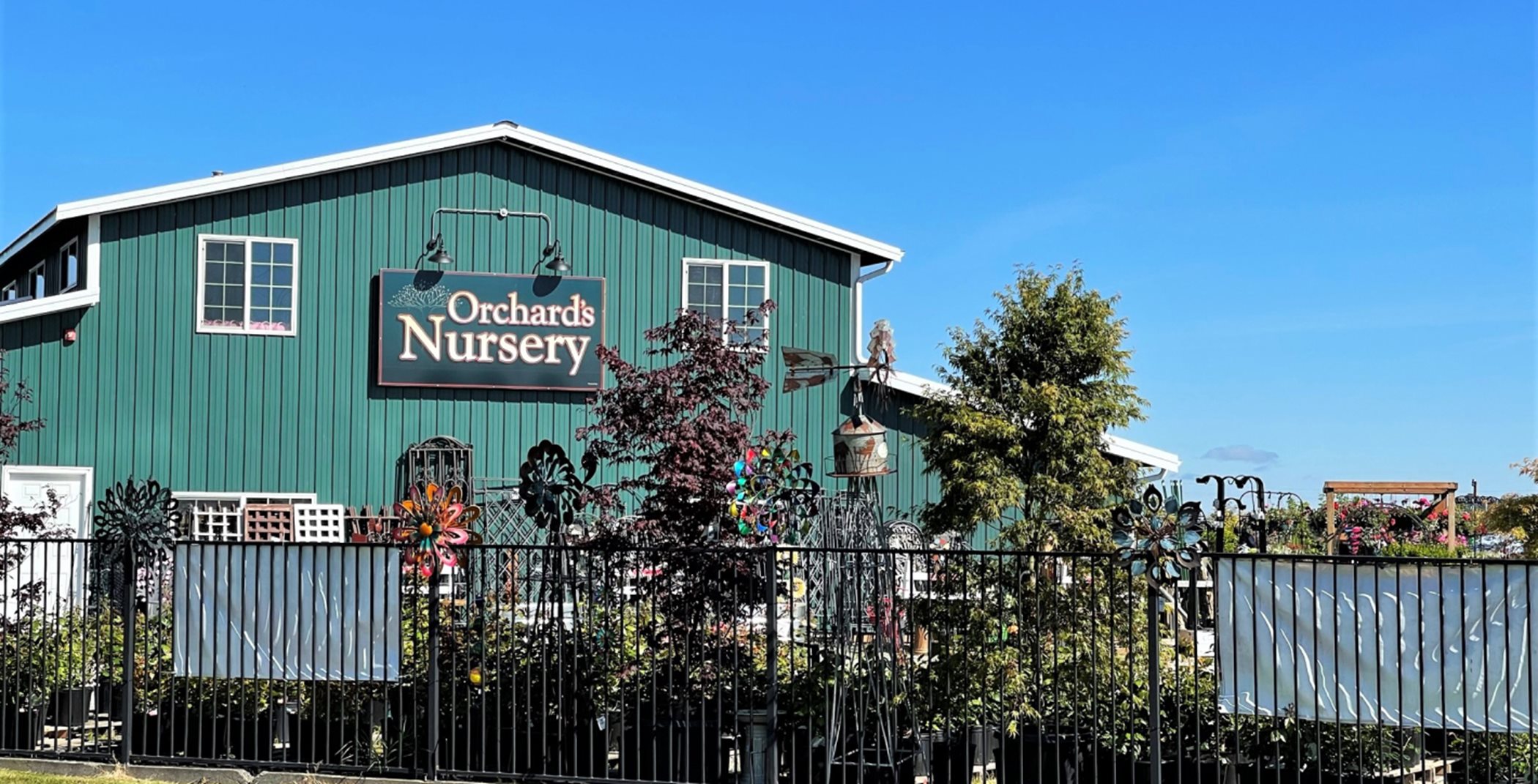 Orchard's Nursery Building. It is green and resembles a house.