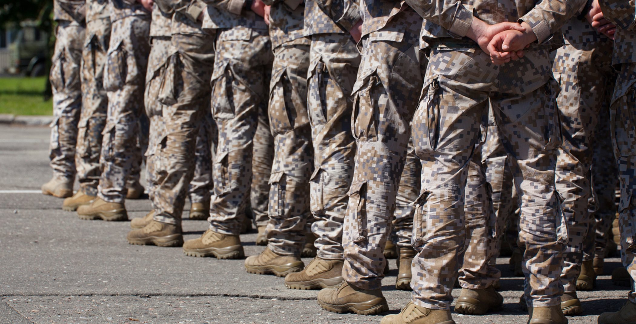 A line of people in army uniforms. Only the bottom of their bodies are visible.
