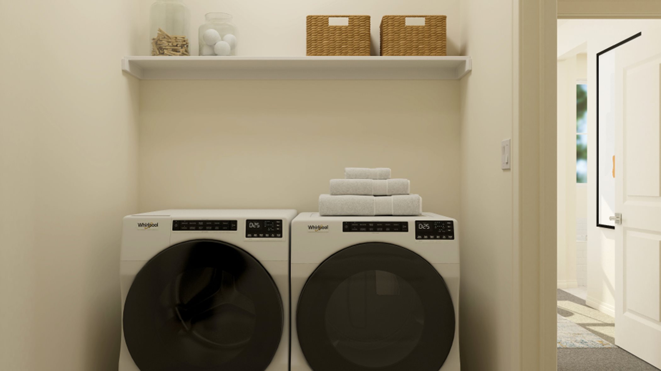 Laundry room with overhead shelving and a washer and dryer