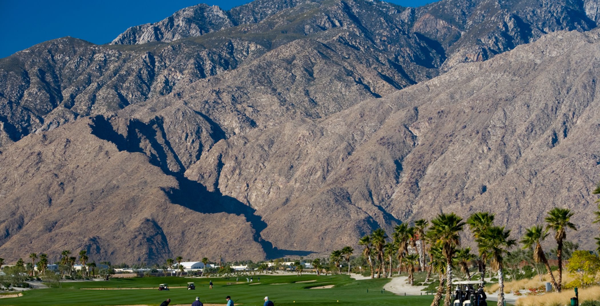 Golf course surrounded by mountains