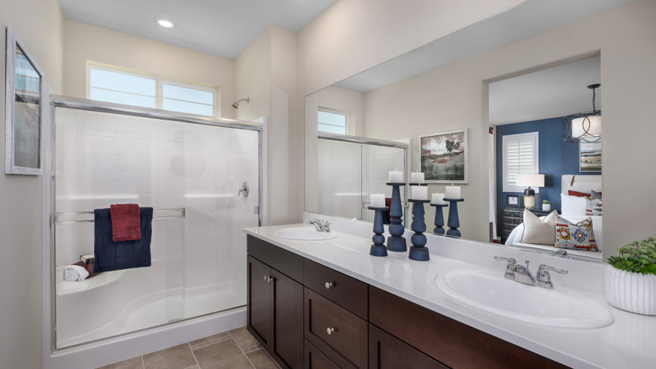 Bathroom with dual sinks and a glass-enclosed shower