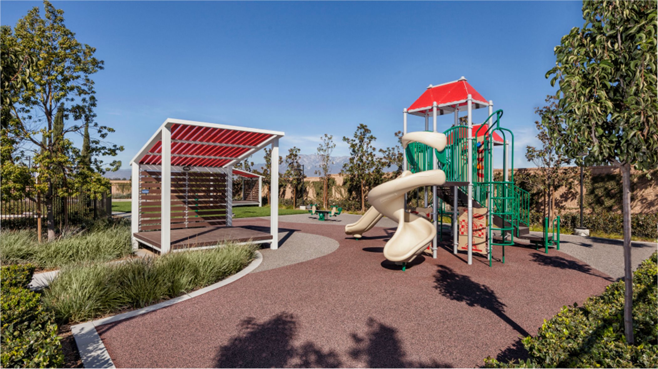 Playground with a shaded area and a playset