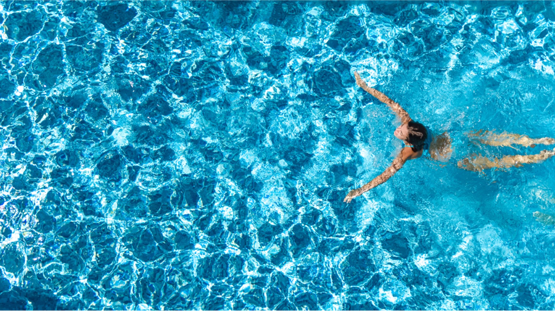 Aerial view of person swimming in a pool