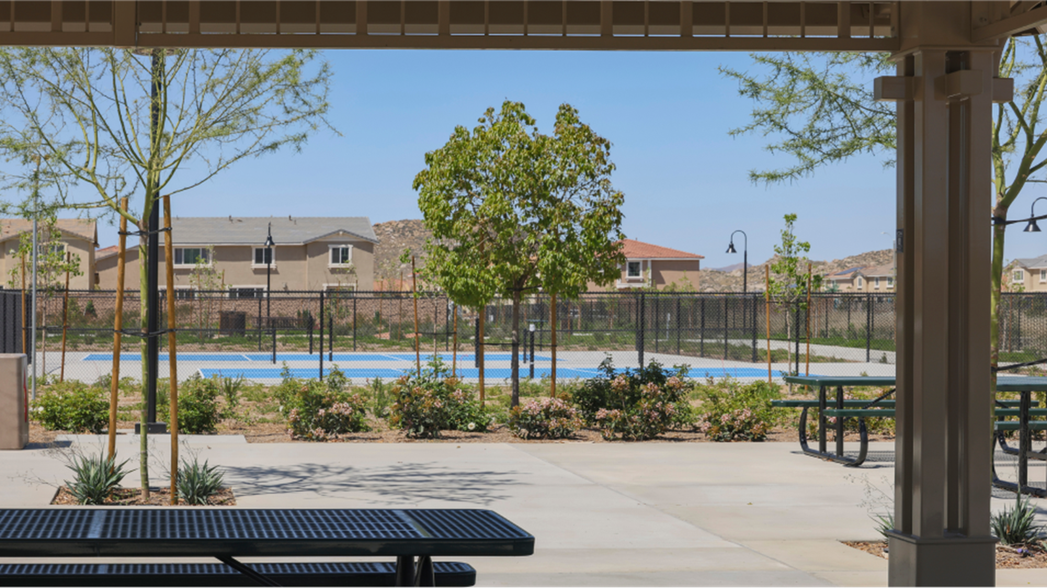 Shaded benches overlooking pickleball courts