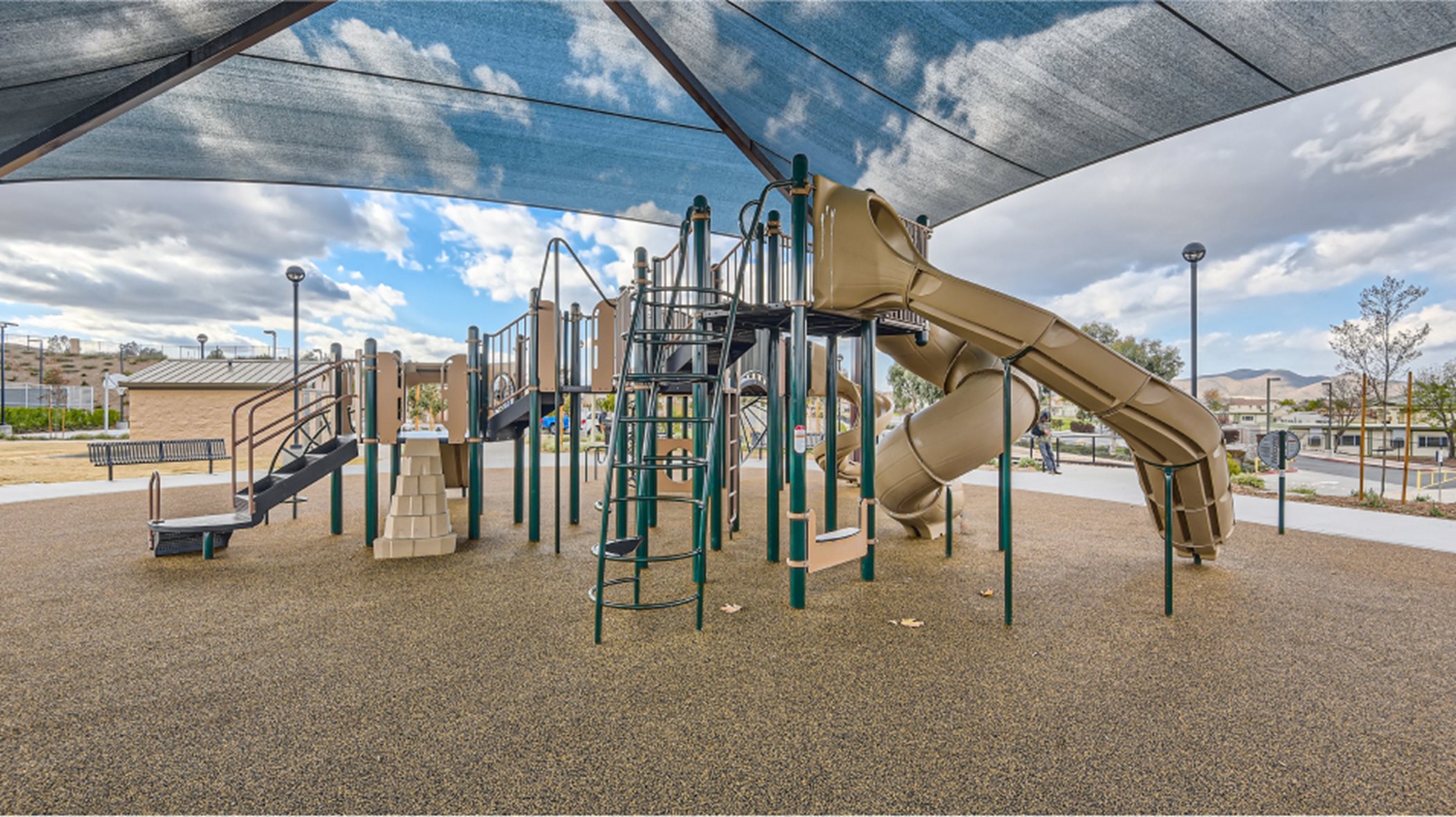 Covered playground area with slide and jungle gym