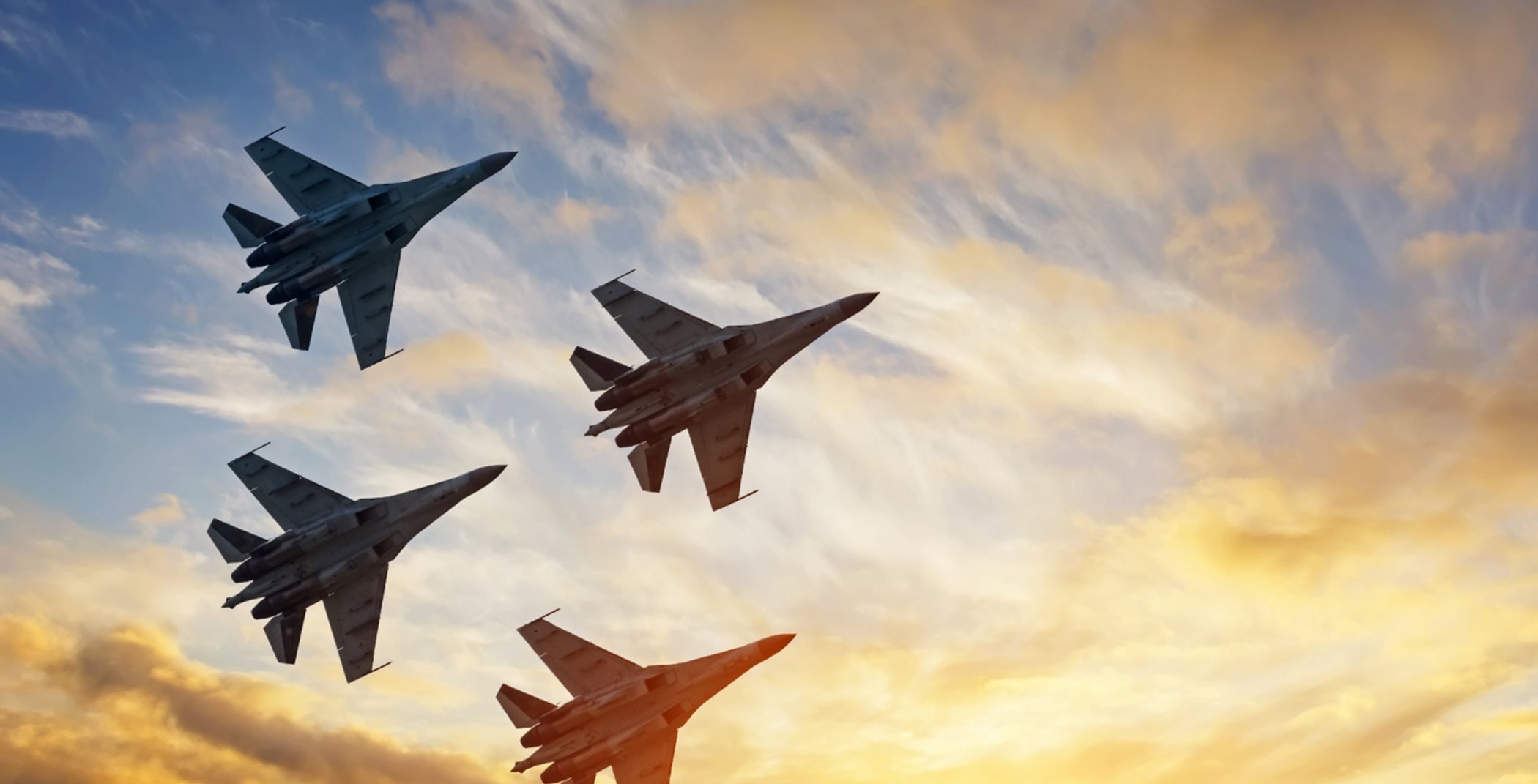 Fighter jets flying in formation ay golden hour