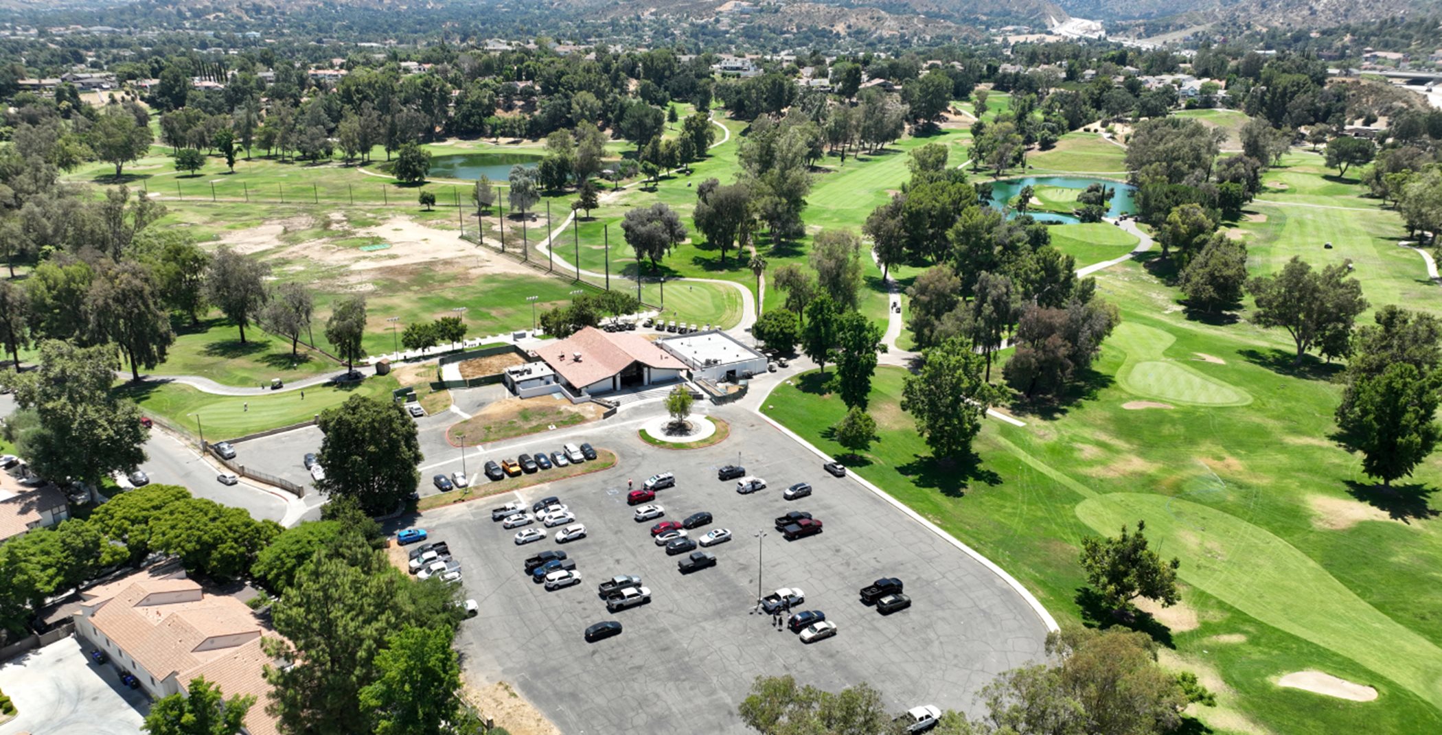 Aerial view of a nearby golf course and parking lot