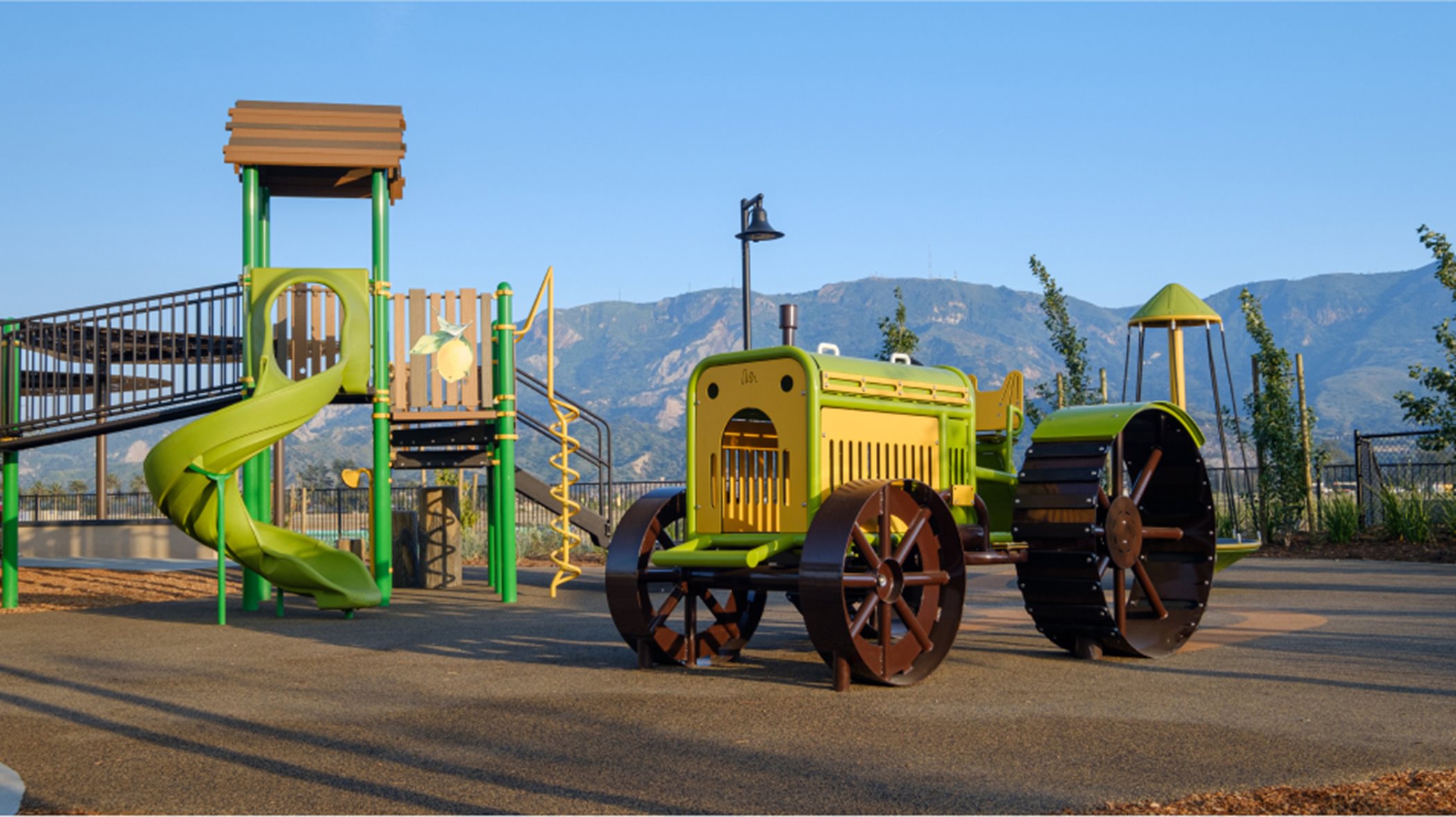 Playground with a play apparatus and fake tractor