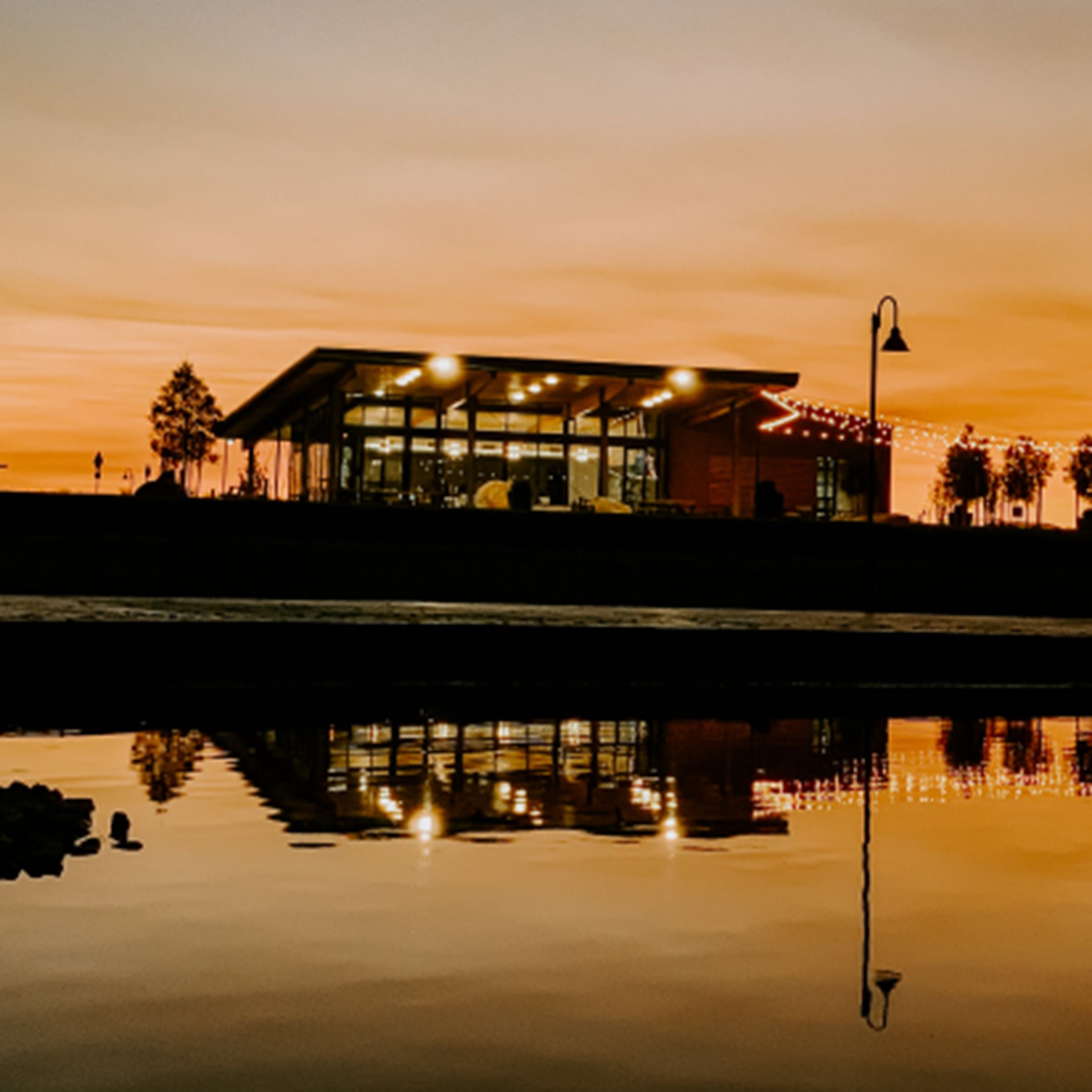 One Lake glass house at dusk