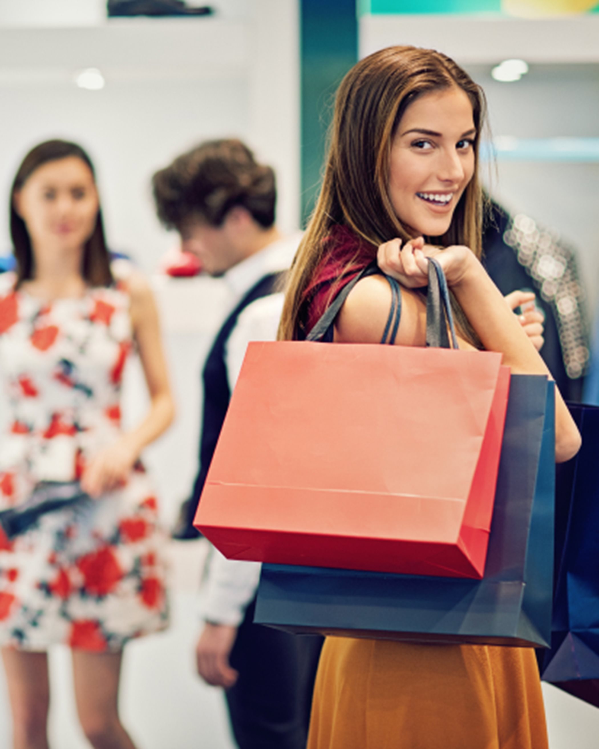 Woman smiling while shopping and holding her bags