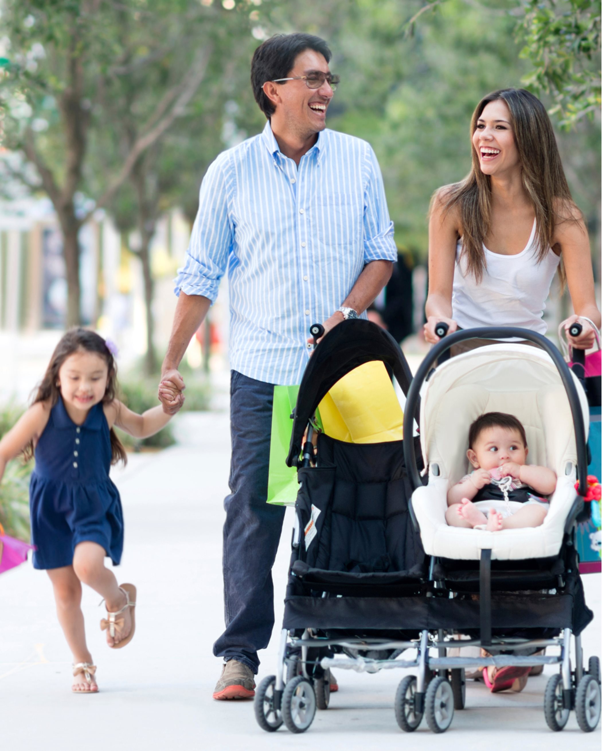 Family with stroller walking on sidewalk