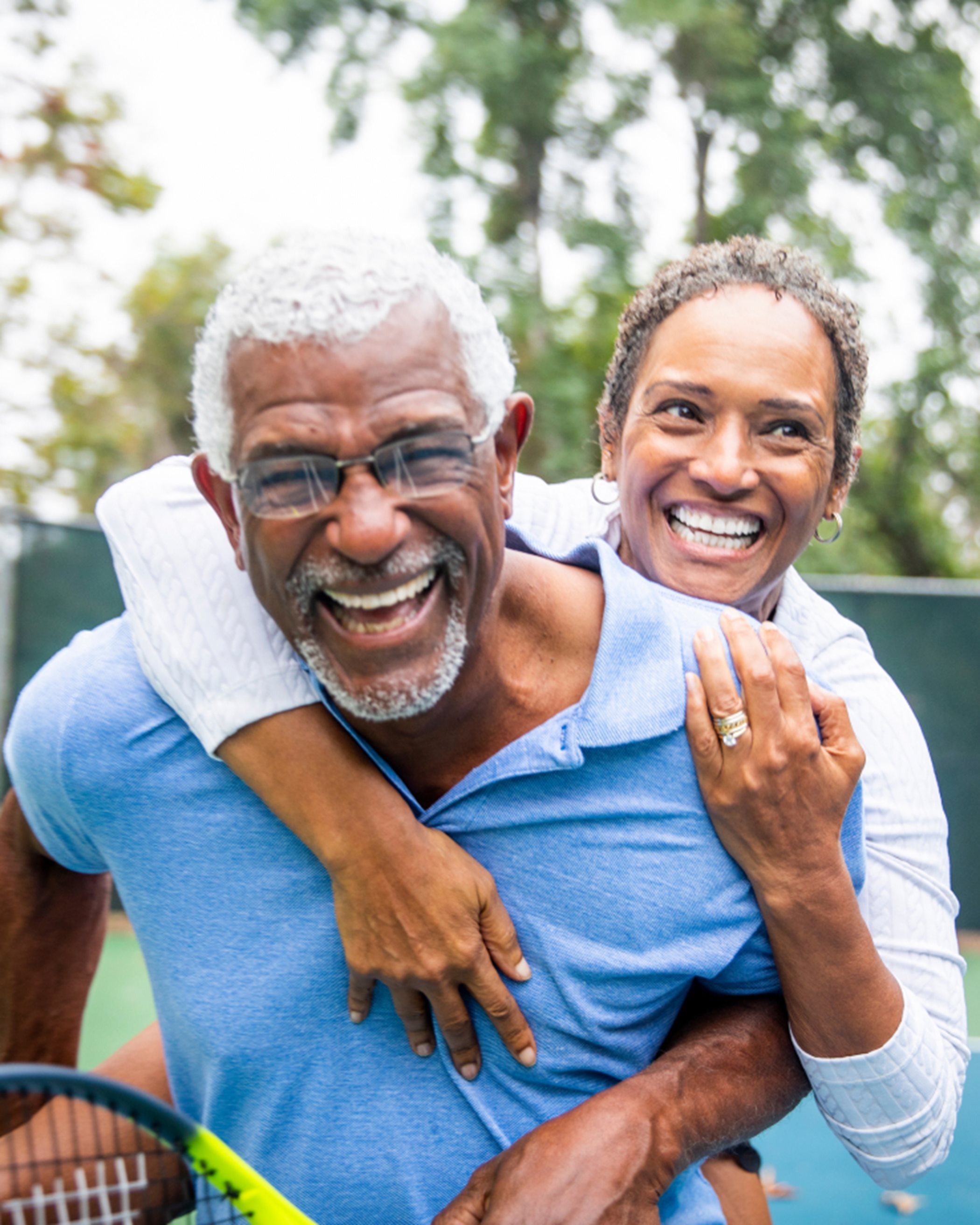 Couple smiling at tennis court