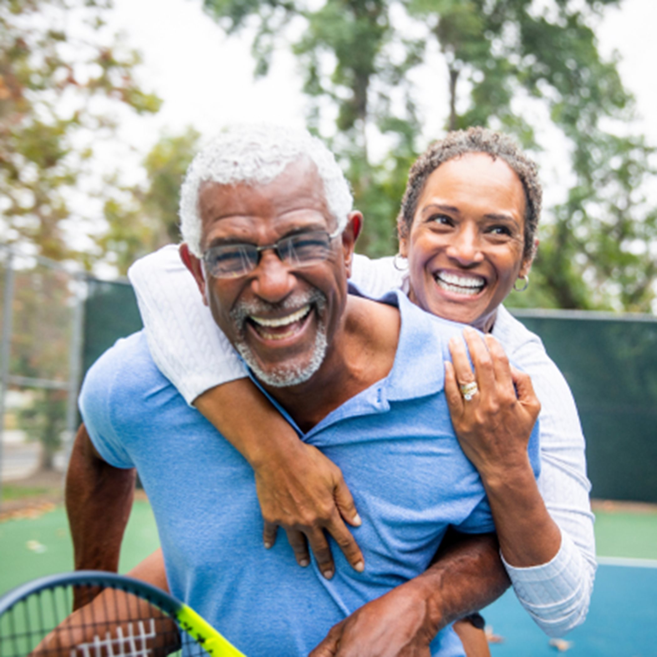 Couple smiling at tennis court