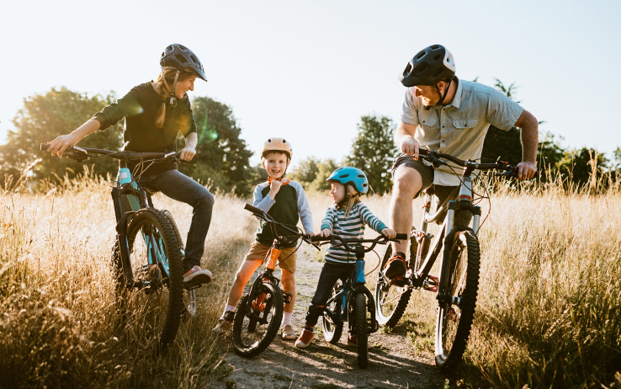 Family biking together on bike trail