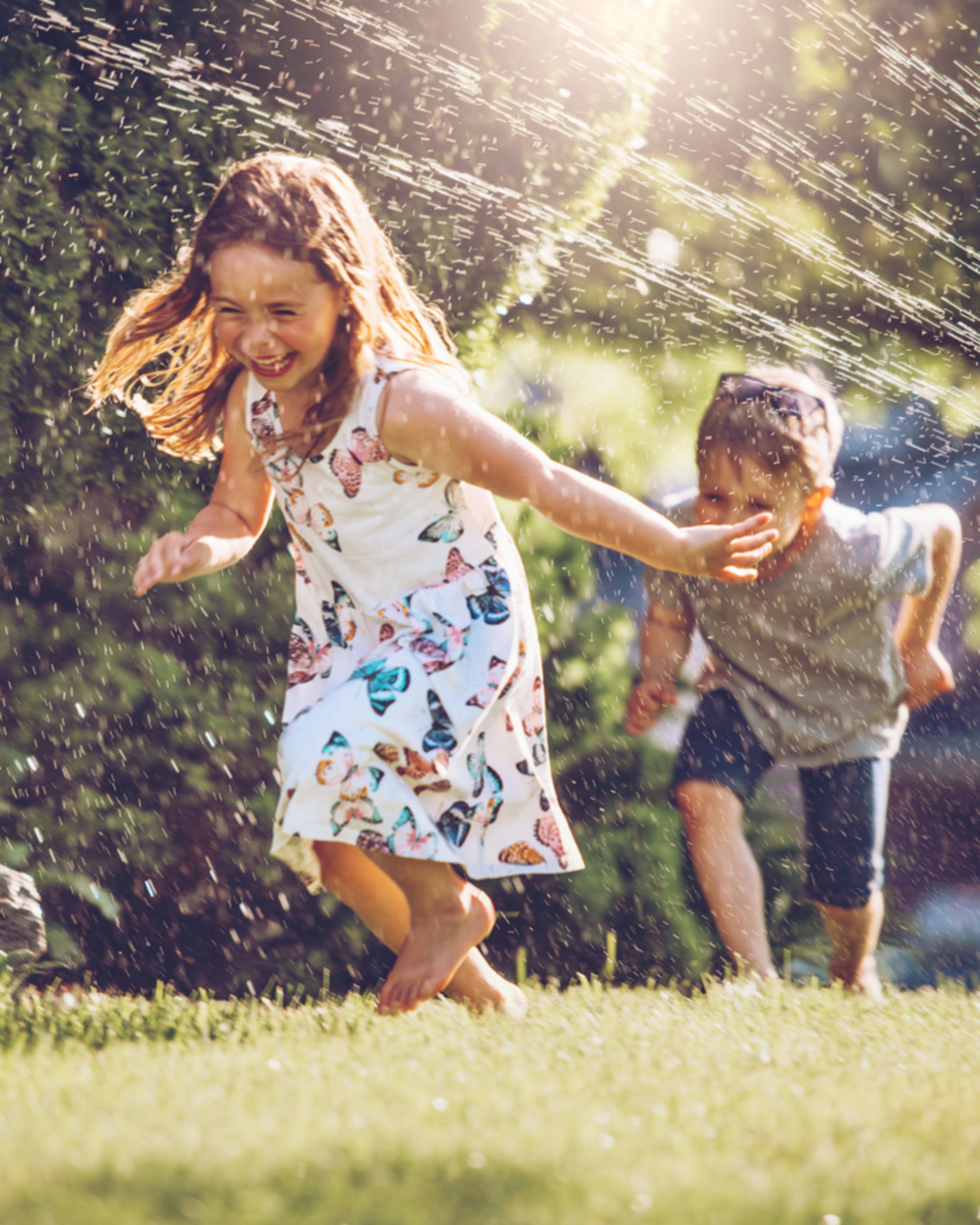 Kids playing in sprinkler