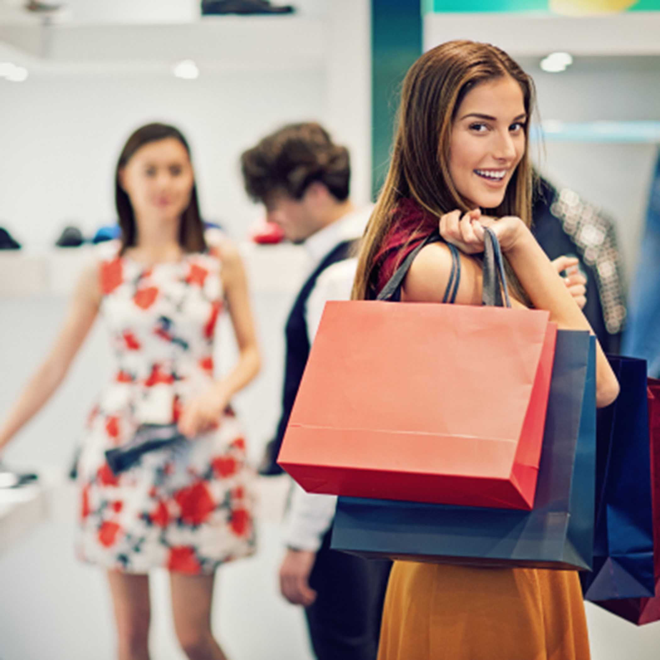 Woman smiling and holding shopping bags
