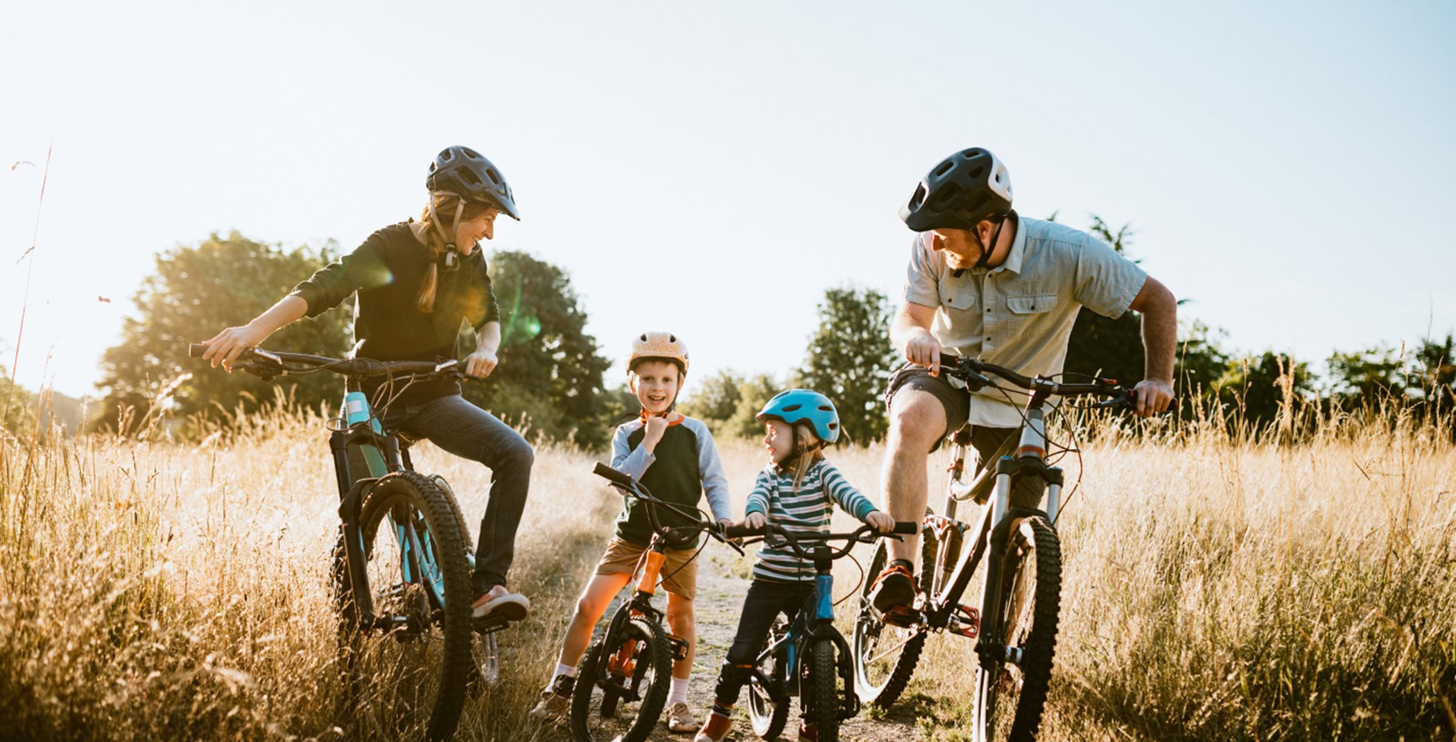 Family riding bikes together on a trail