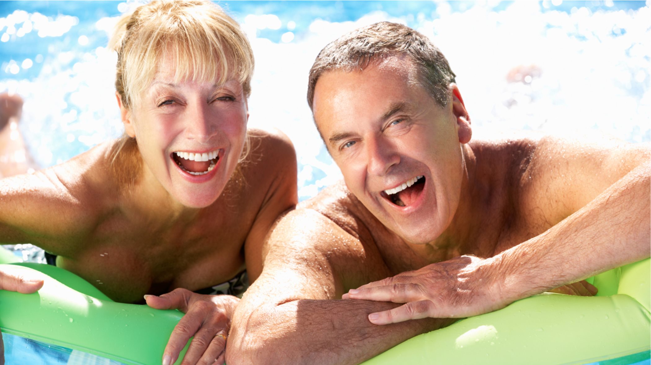 Couple laughing in swimming pool 