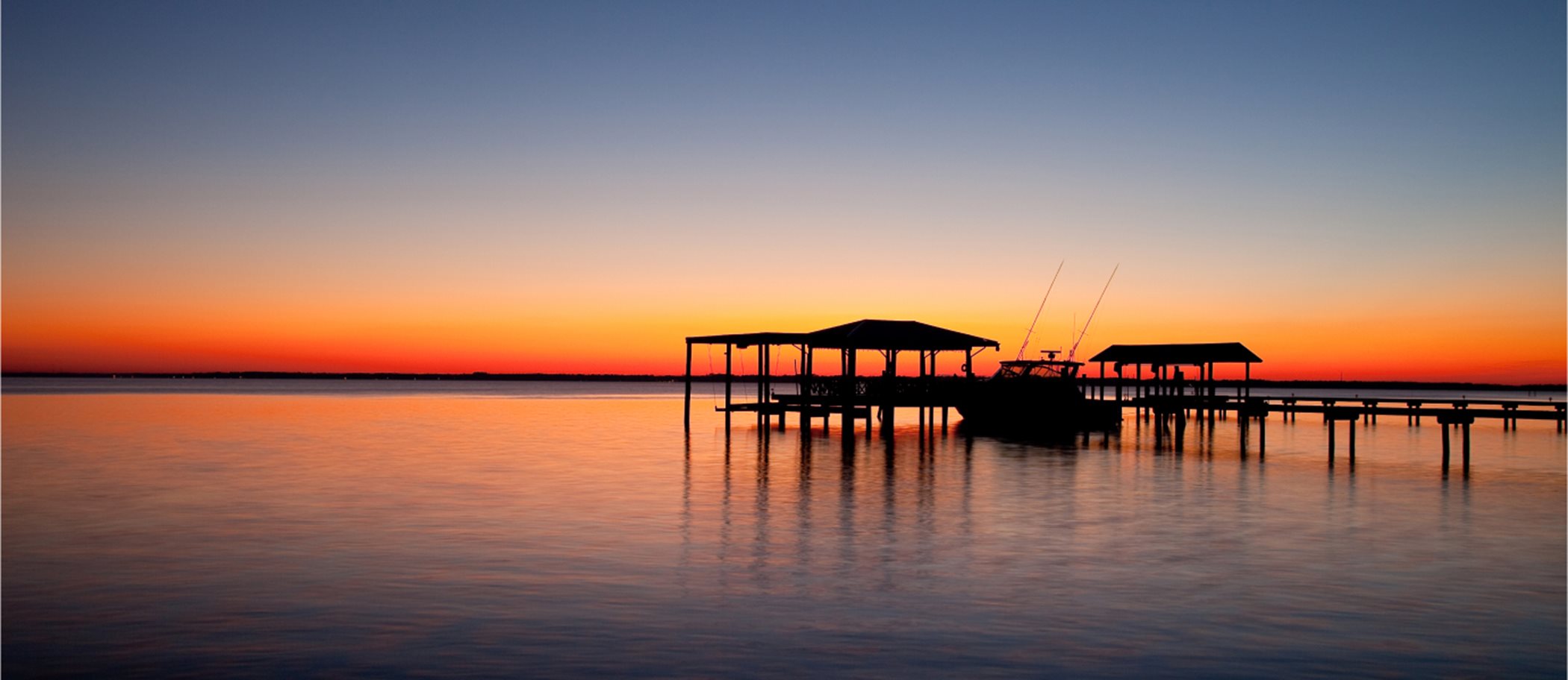 Boat at a dock at sunset