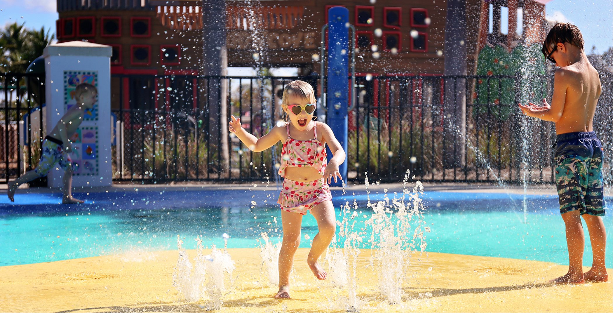 Little girl playing in splash park