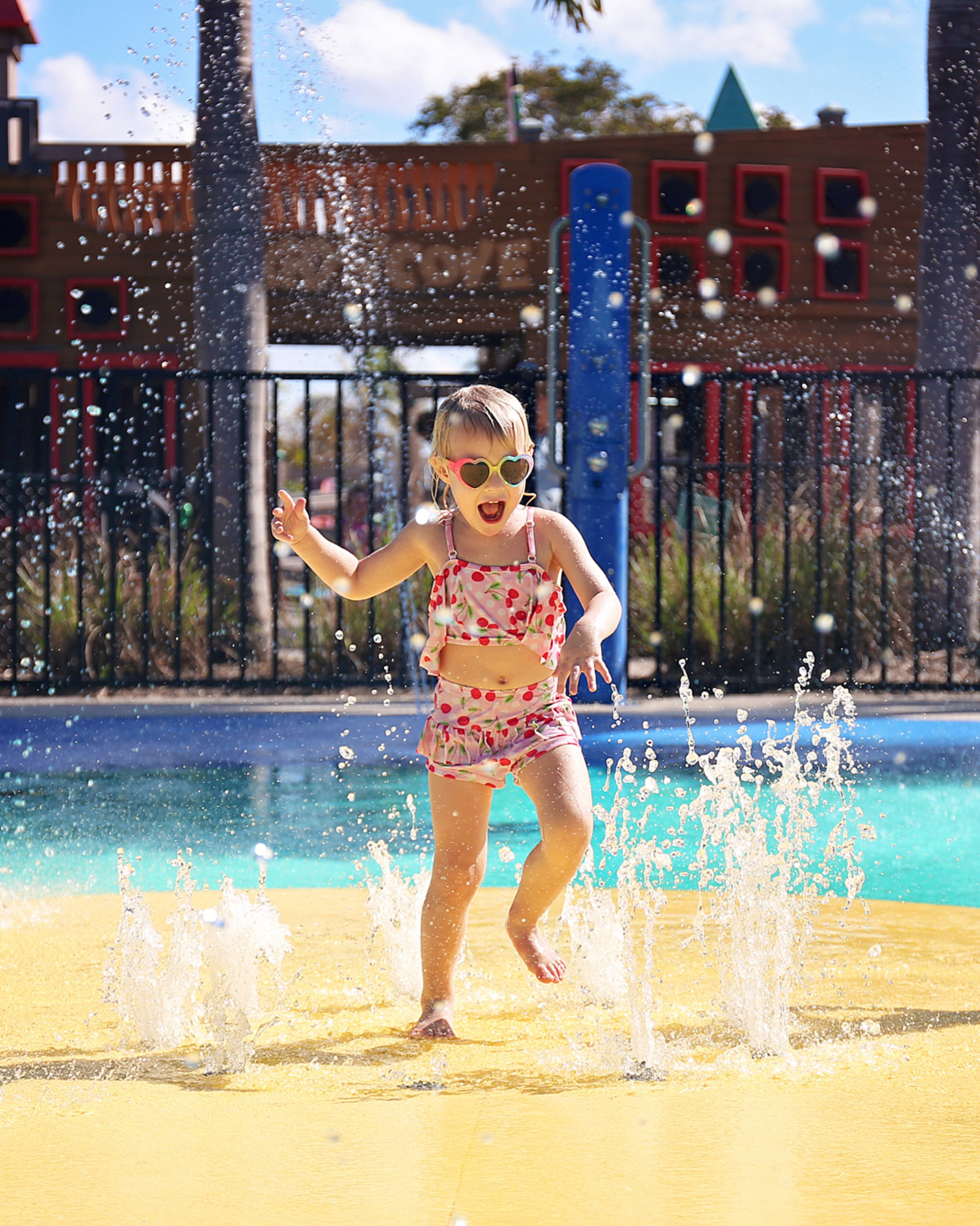 Little girl playing in splash park