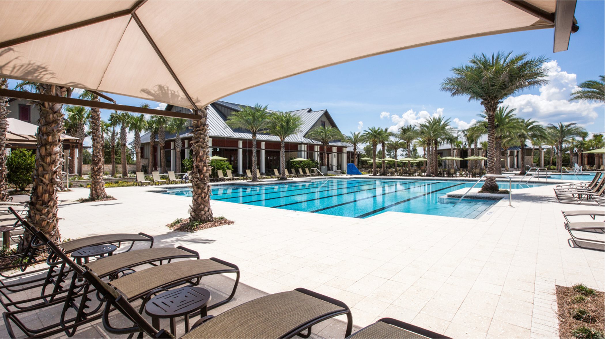Swimming pool and lounge area located outside clubhouse