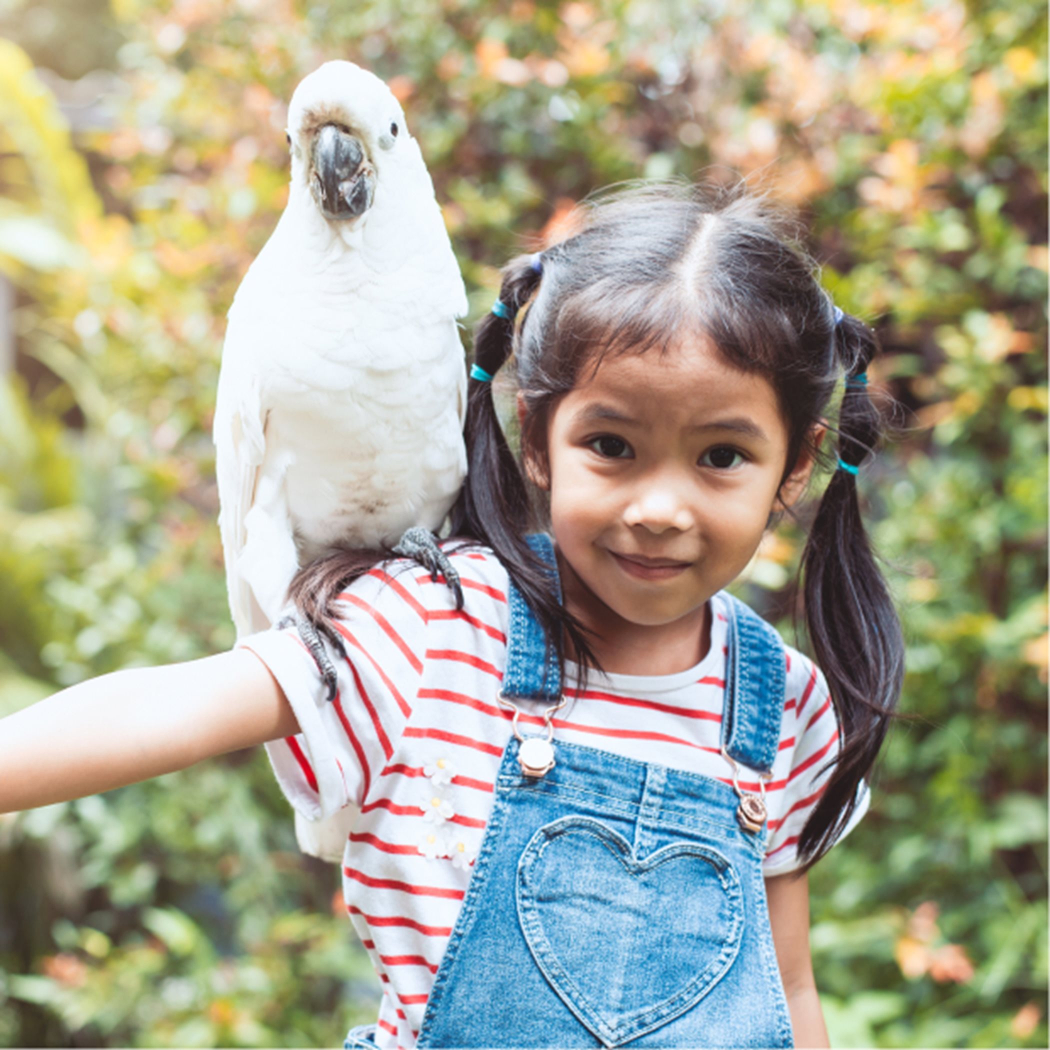 Girl with parrot at her shoulder