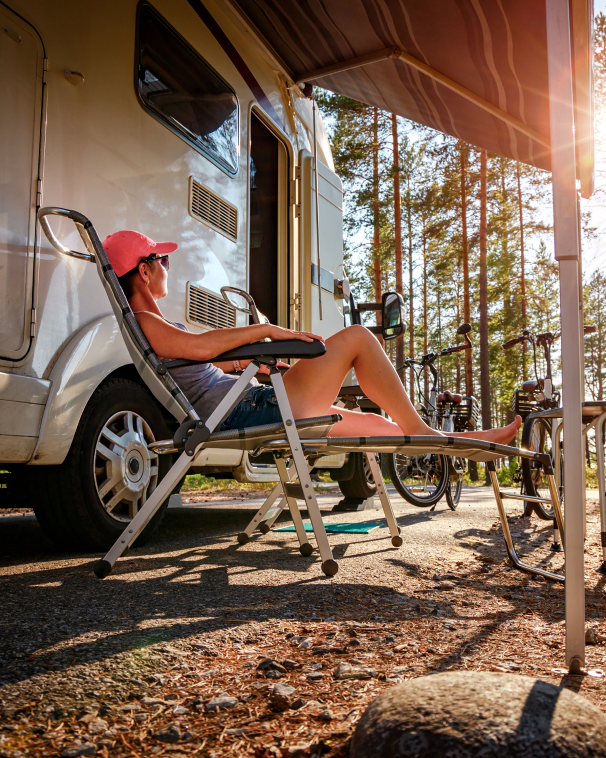 Woman lounging in front of an RV