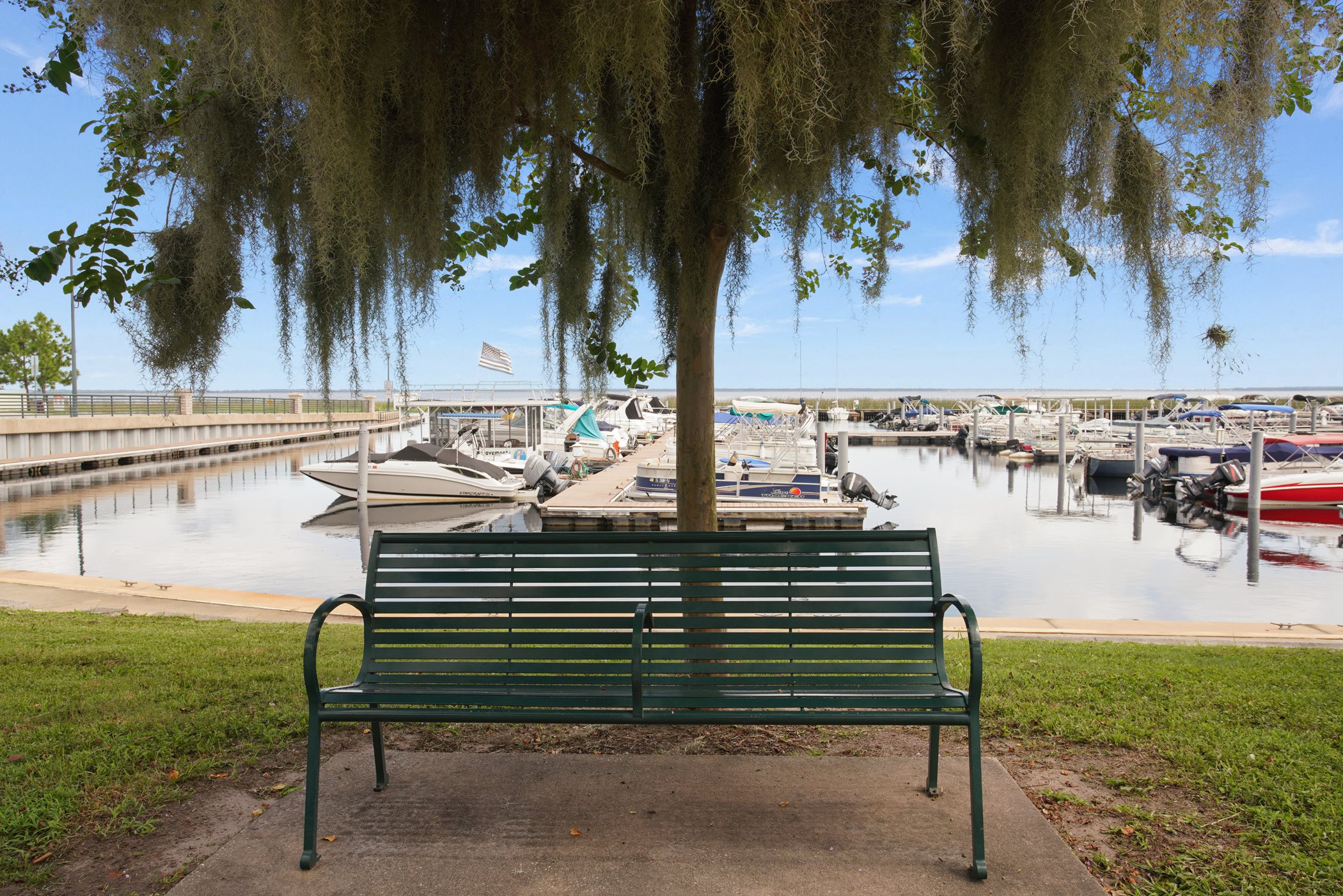 A bench overlooking the beautiful marina and docked boats