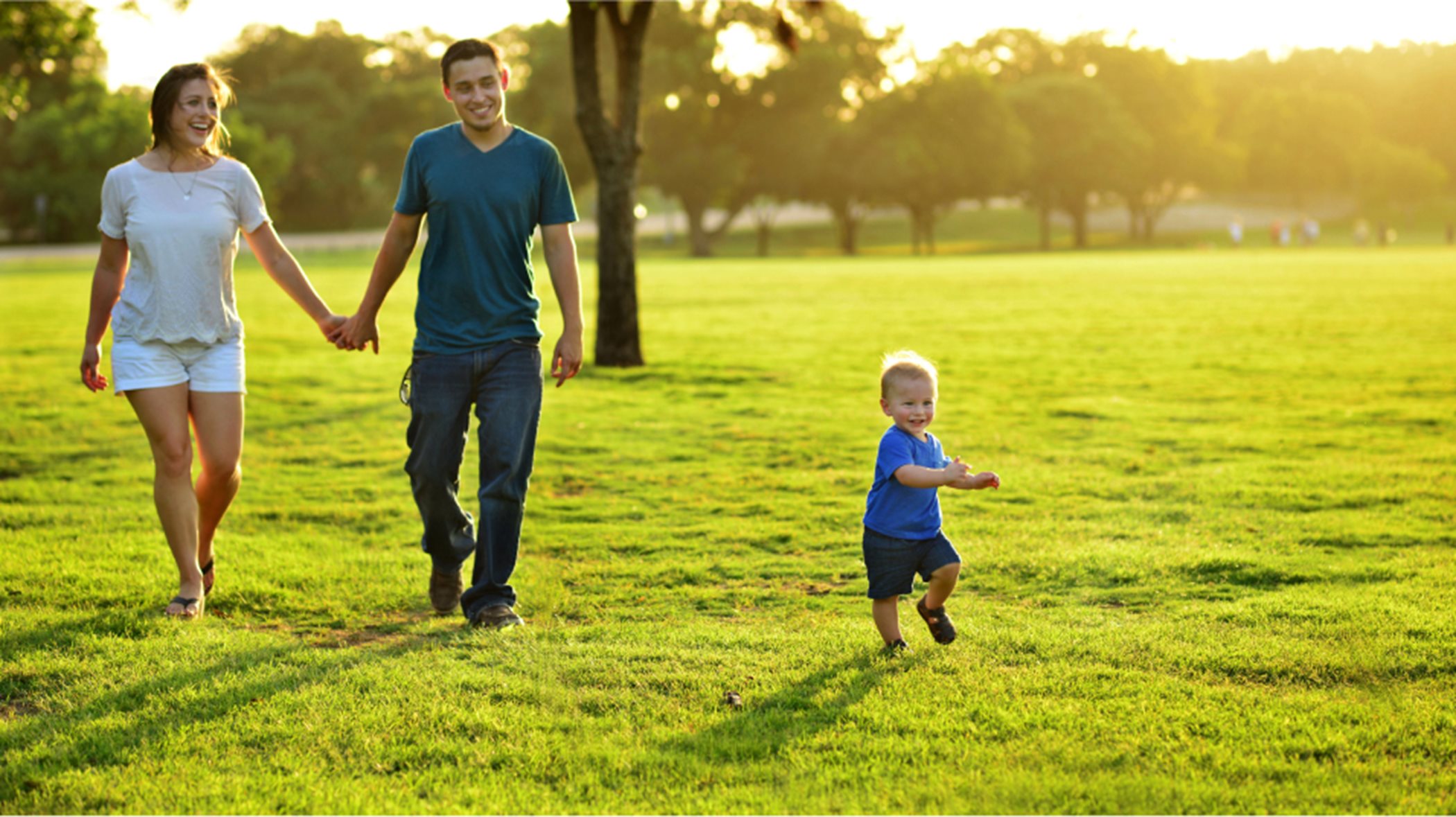 Couple walking with child running