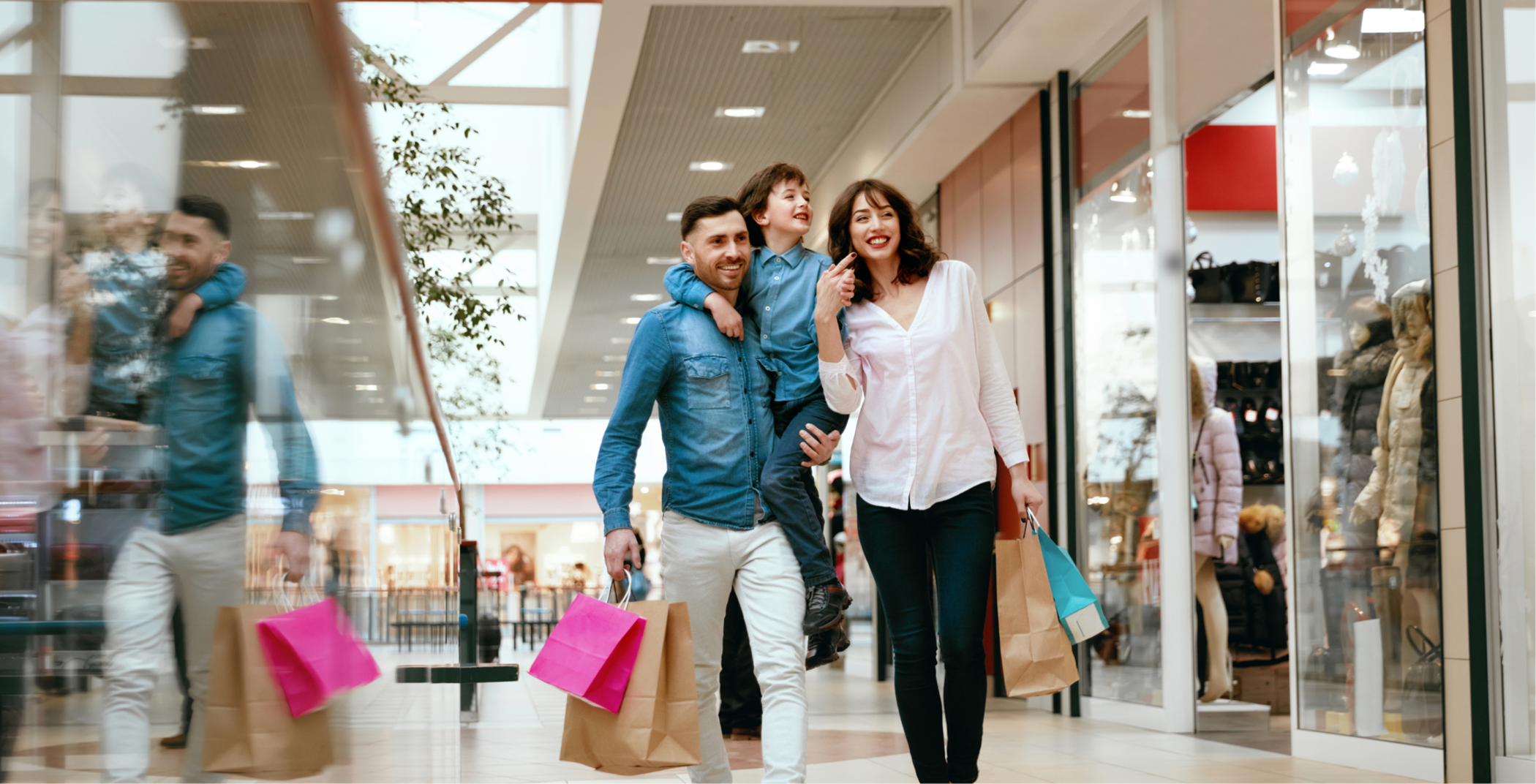 Stock image of young family in a mall