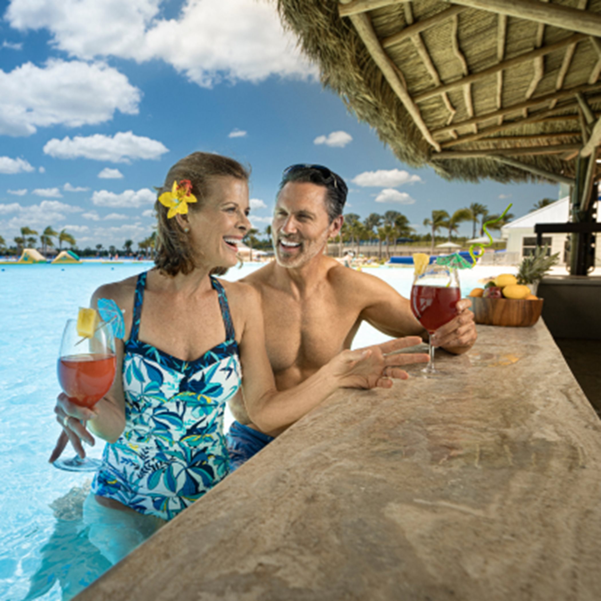 Two people enjoying a drink at a swim up bar