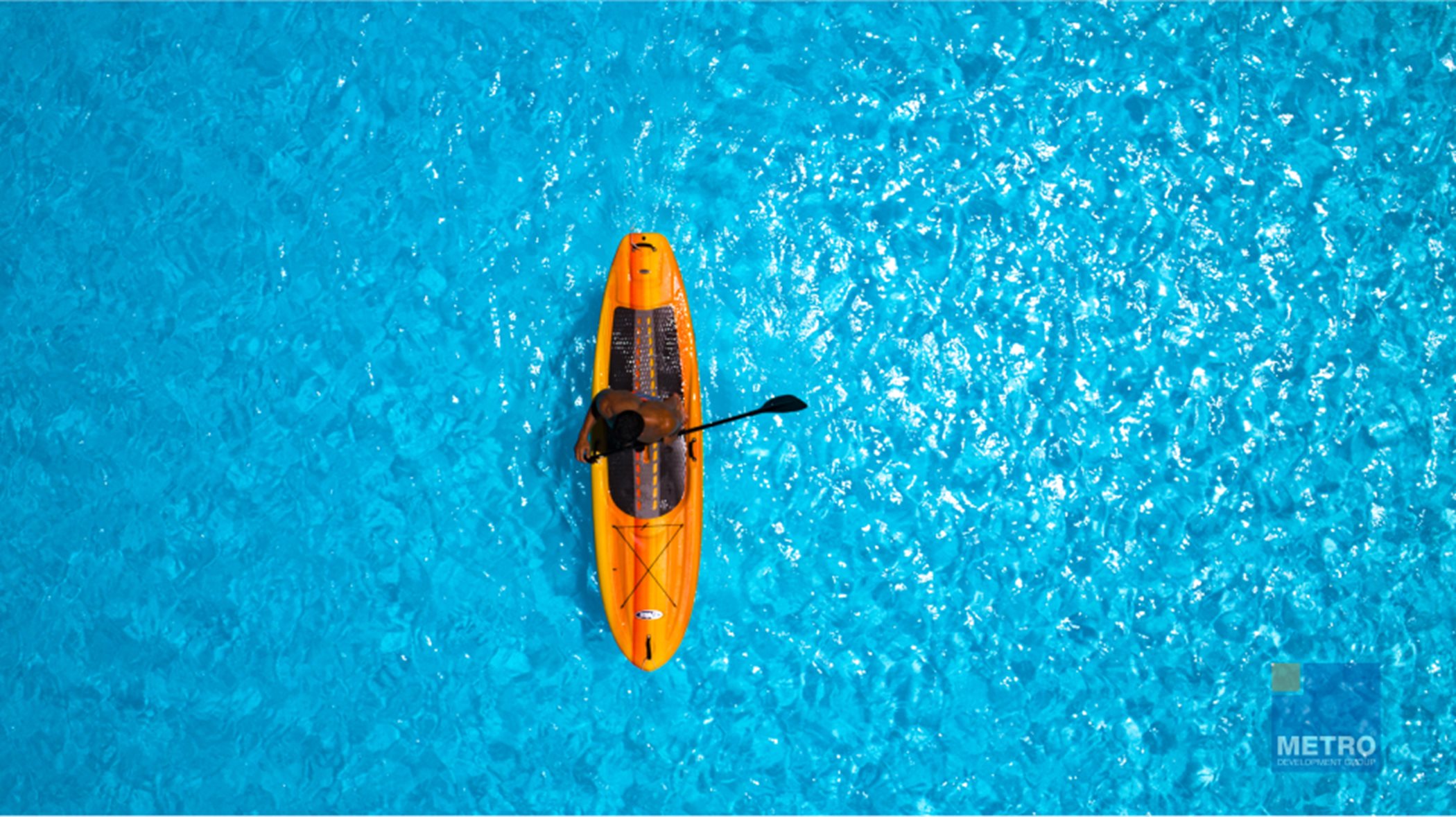 Above view of someone kayaking on crystal lagoon