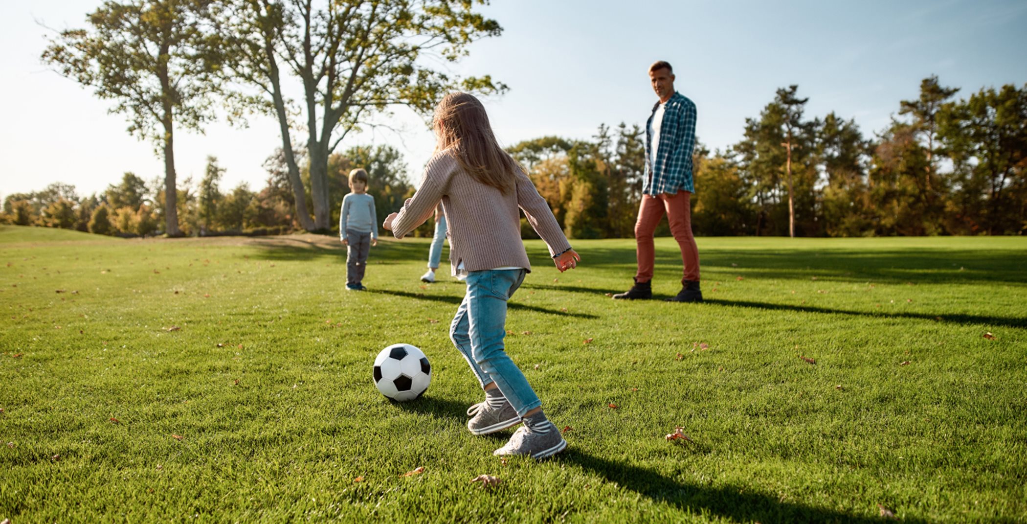 A family playing soccer in a field