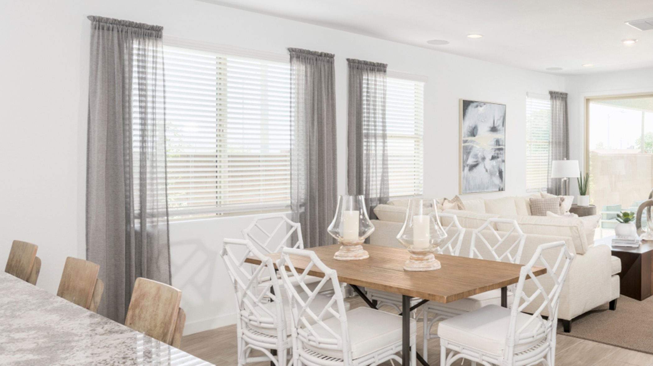 Furnished living and dining area with faux window blinds 