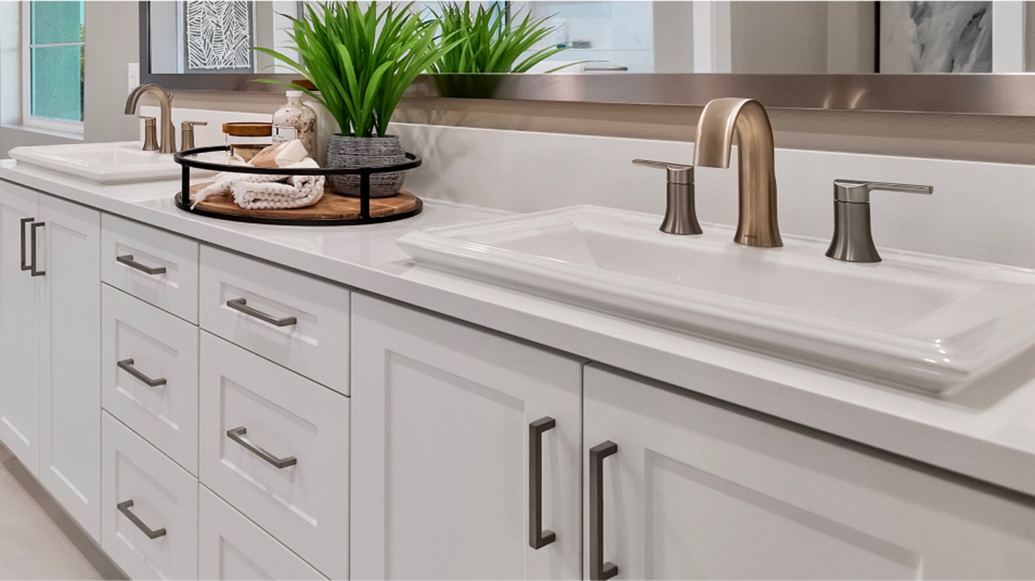 Vanities with Shaker-style cabinetry, Piedrafina™ countertops and 6" backsplashes