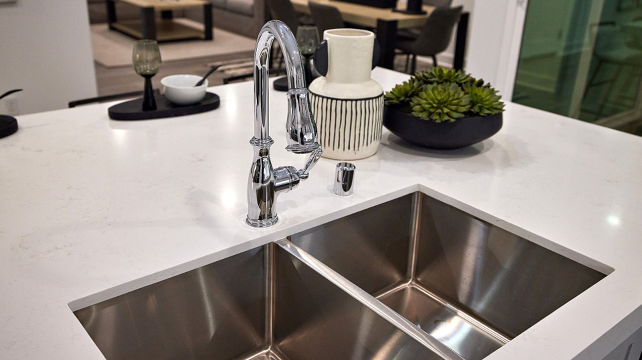 A stainless steel dual-basin sink is complemented by a designer Moen® faucet