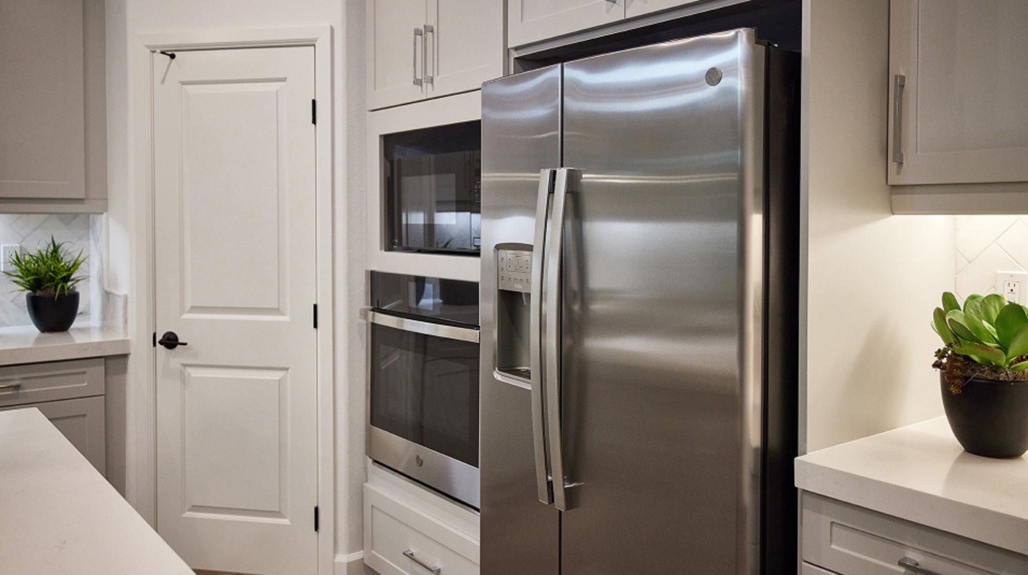 A brand-new GE Profile™ side-by-side refrigerator is included in the stainless steel appliance package