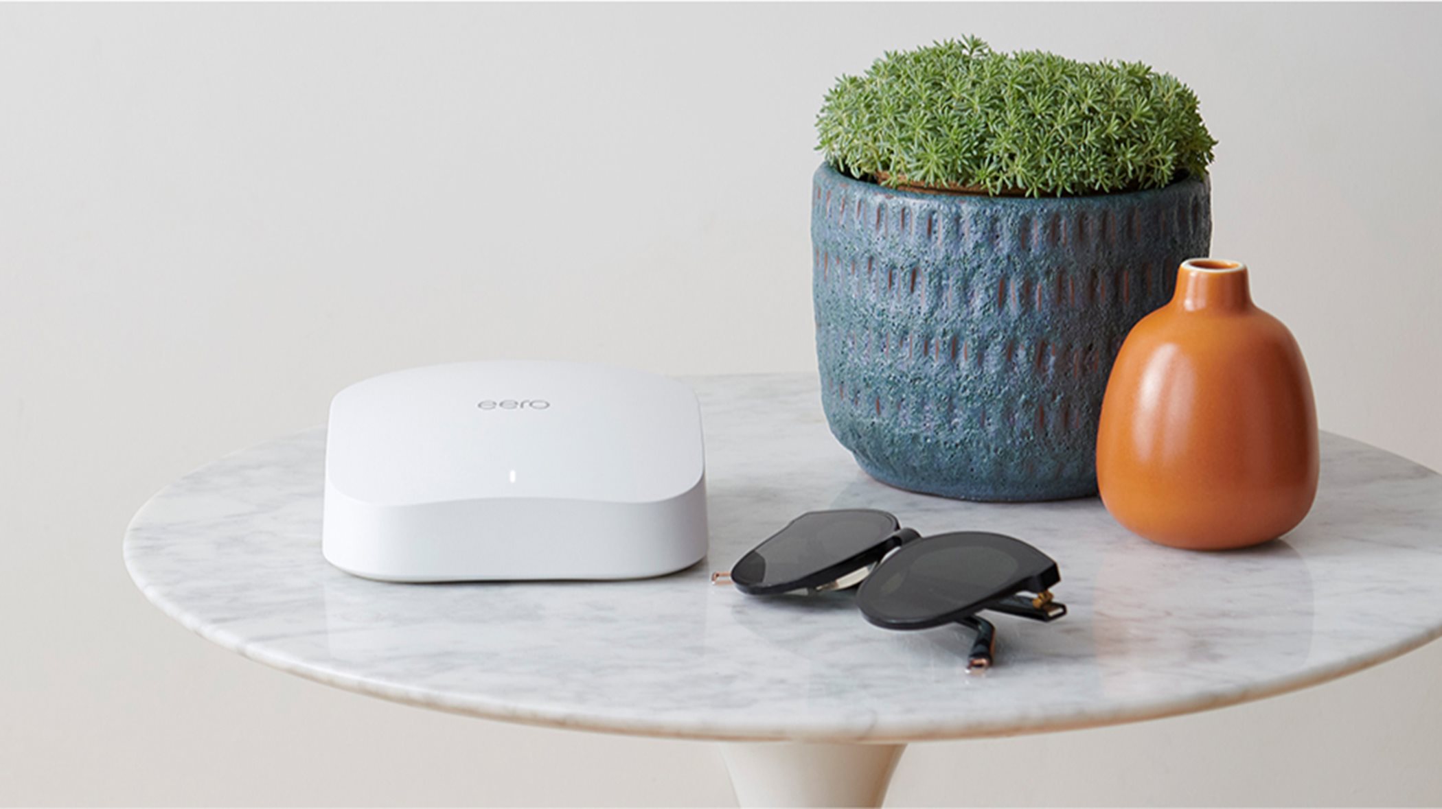 Eero system on a table with plant 